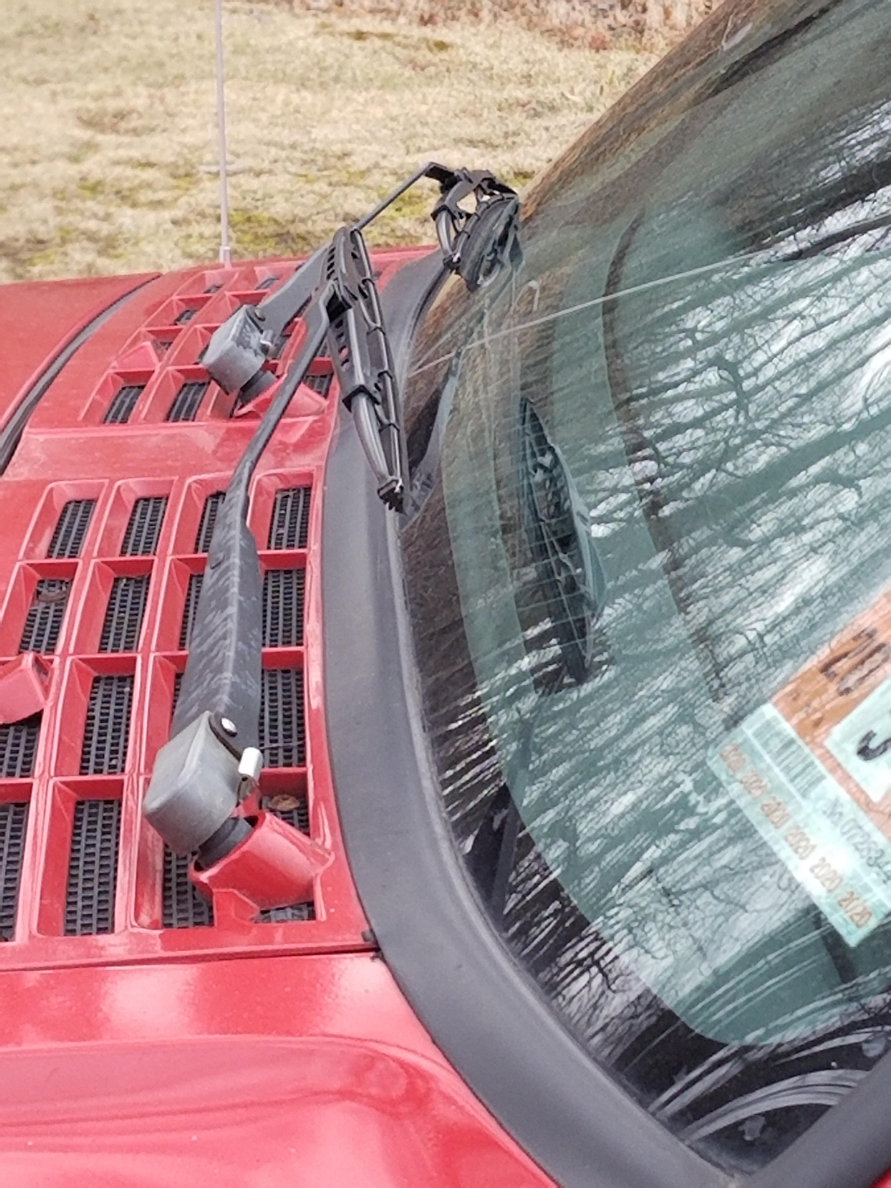 Someone yanked on my windshield wiper and it won't go down, any advice