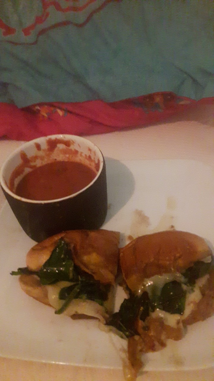 Colby Jack cheese w cooked spinach on a hot dog bun w garlic and