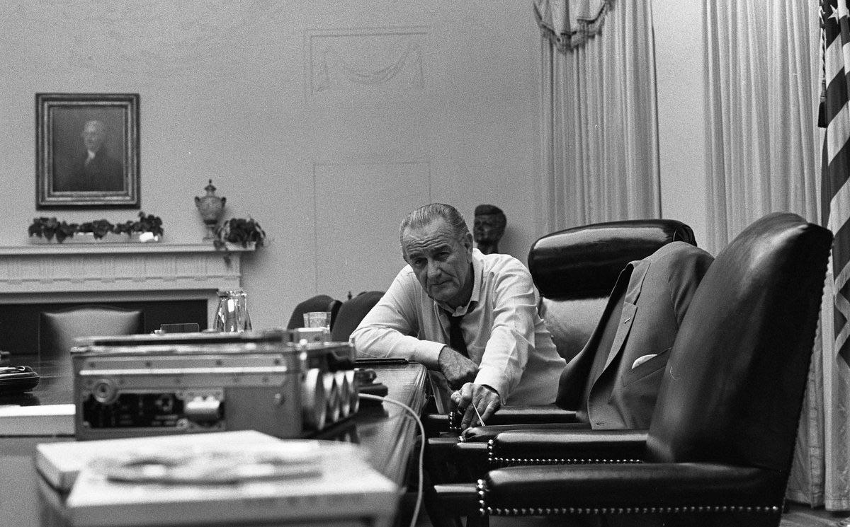 US President Lyndon B Johnson listens to a tape recording sent by his