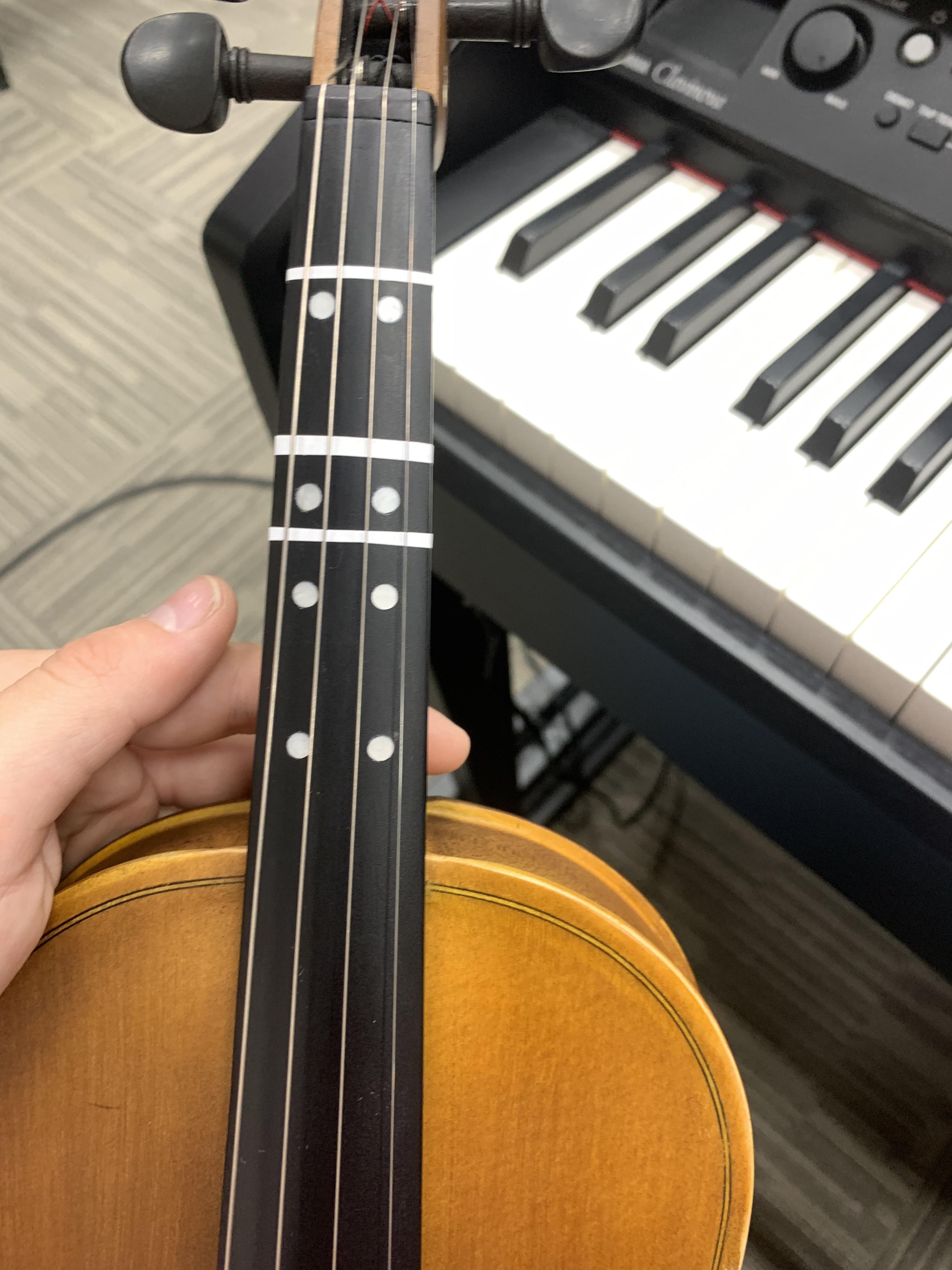 My student’s violin, with permanent markings installed in the