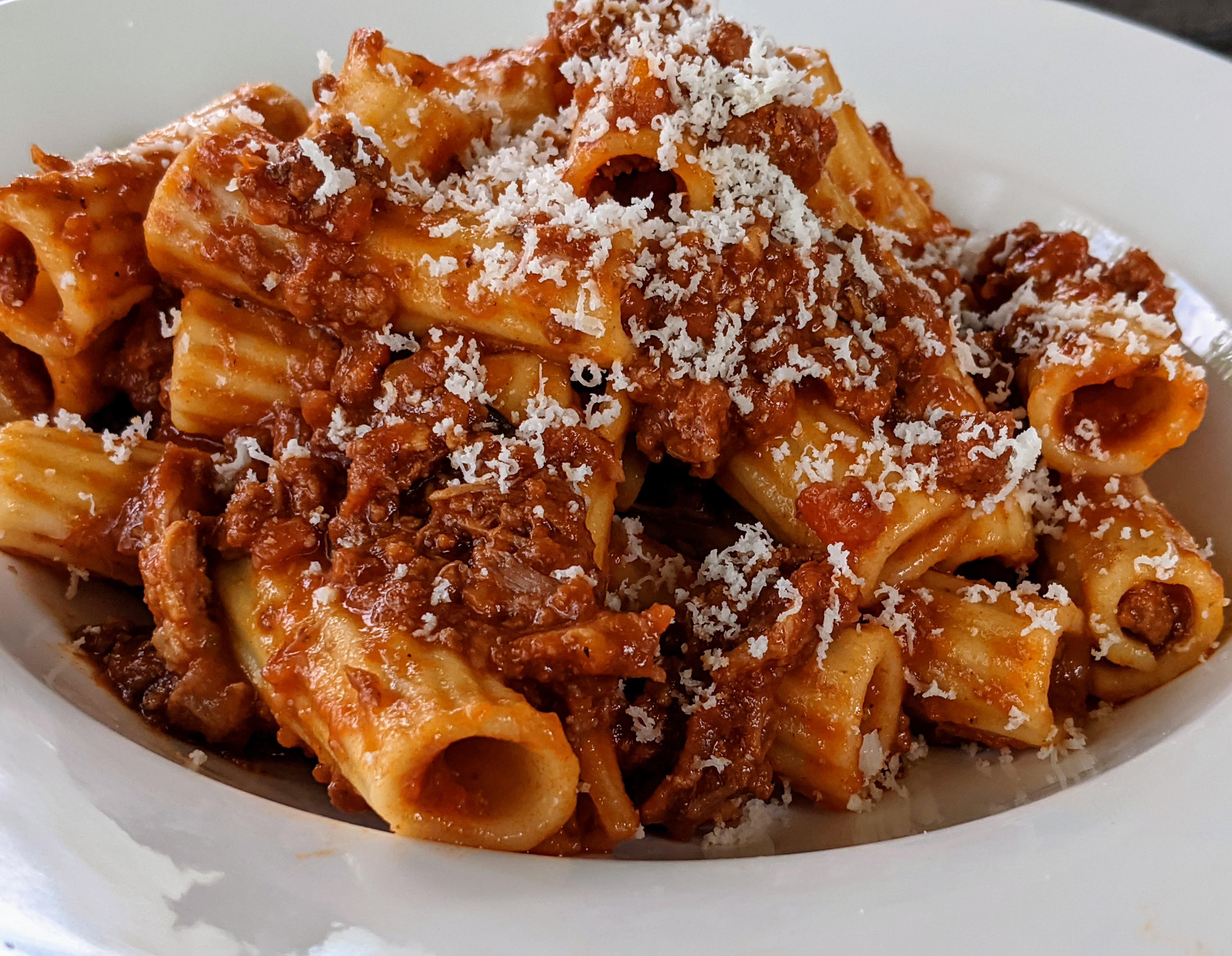Homemade ragù, simmered with pork neck bones and red wine. pasta