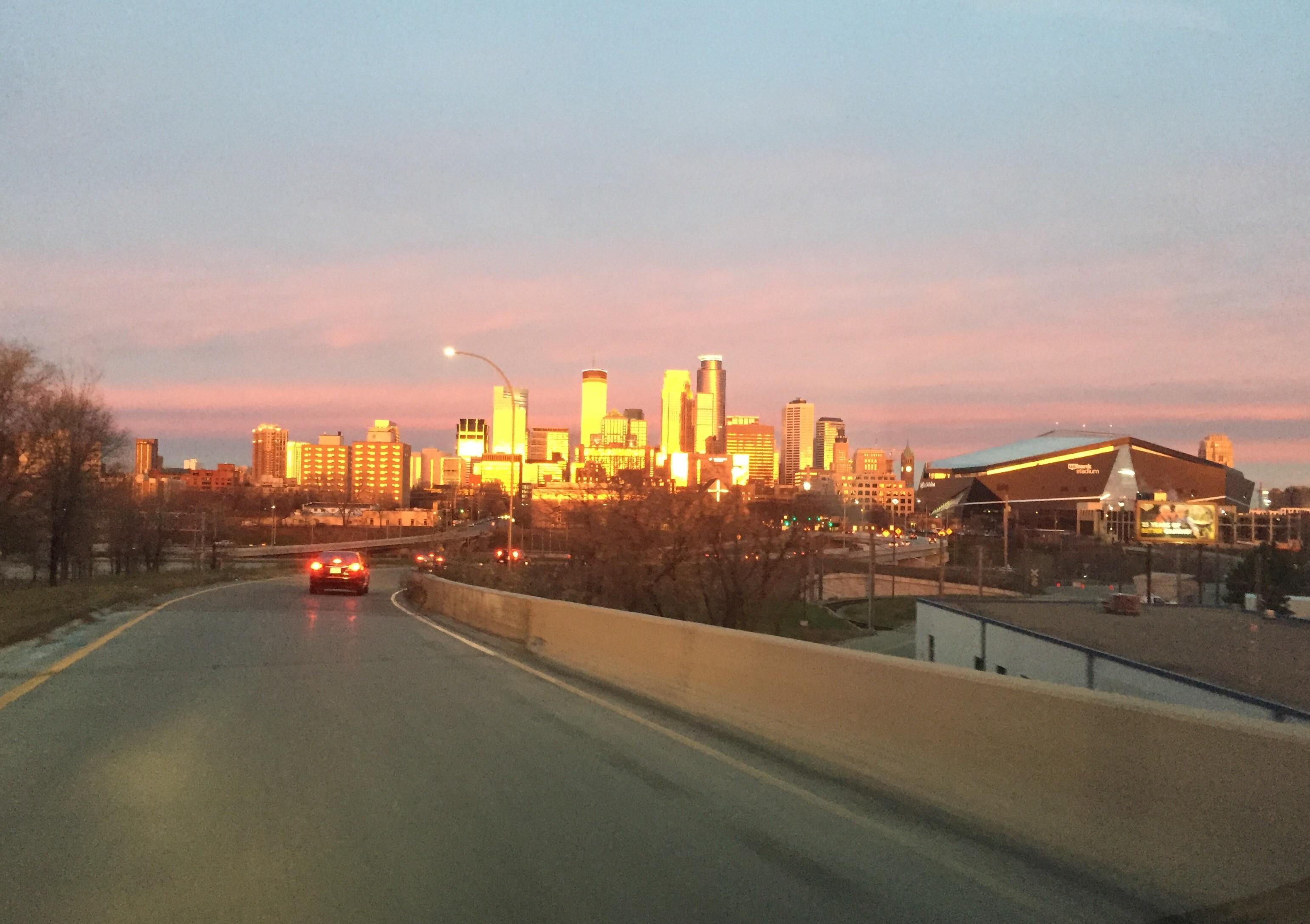 Awesome sunrise this morning made our skyline look gold. r/Minneapolis
