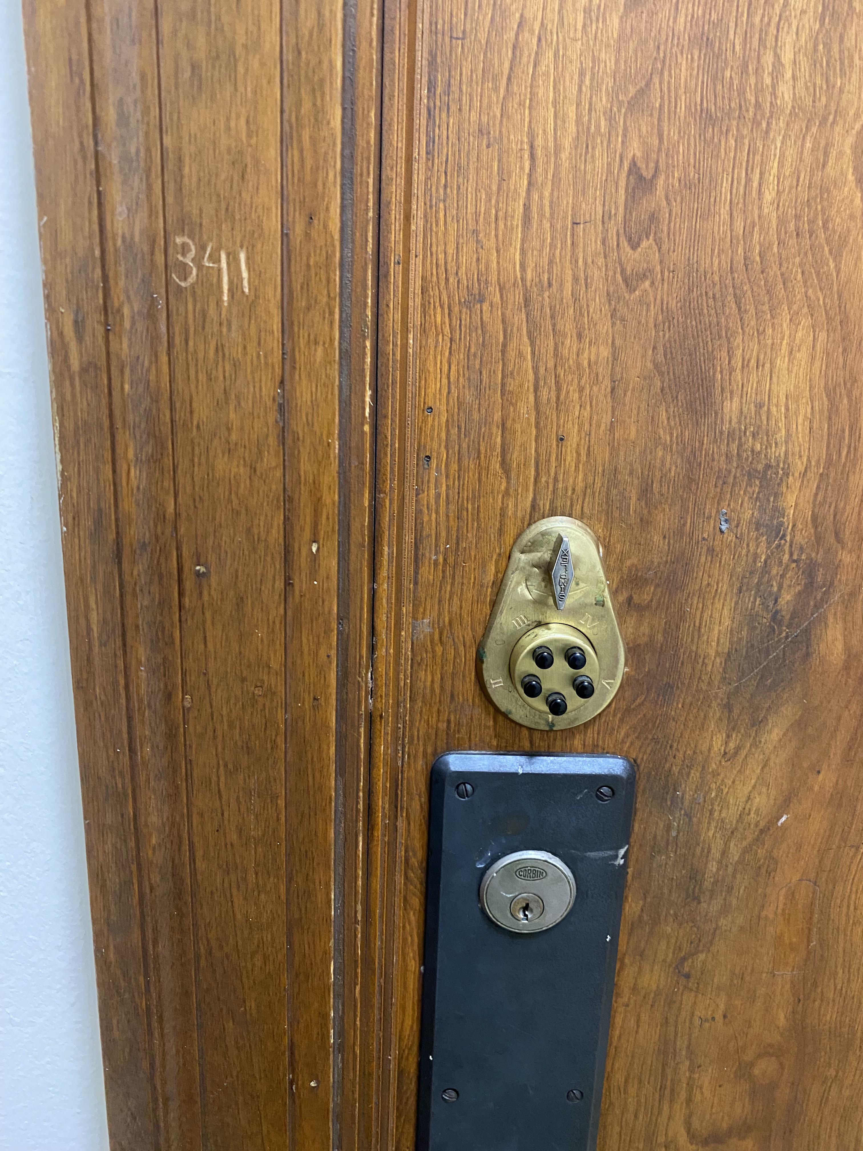 This fancy lock to the bathroom complete with code etched on door frame