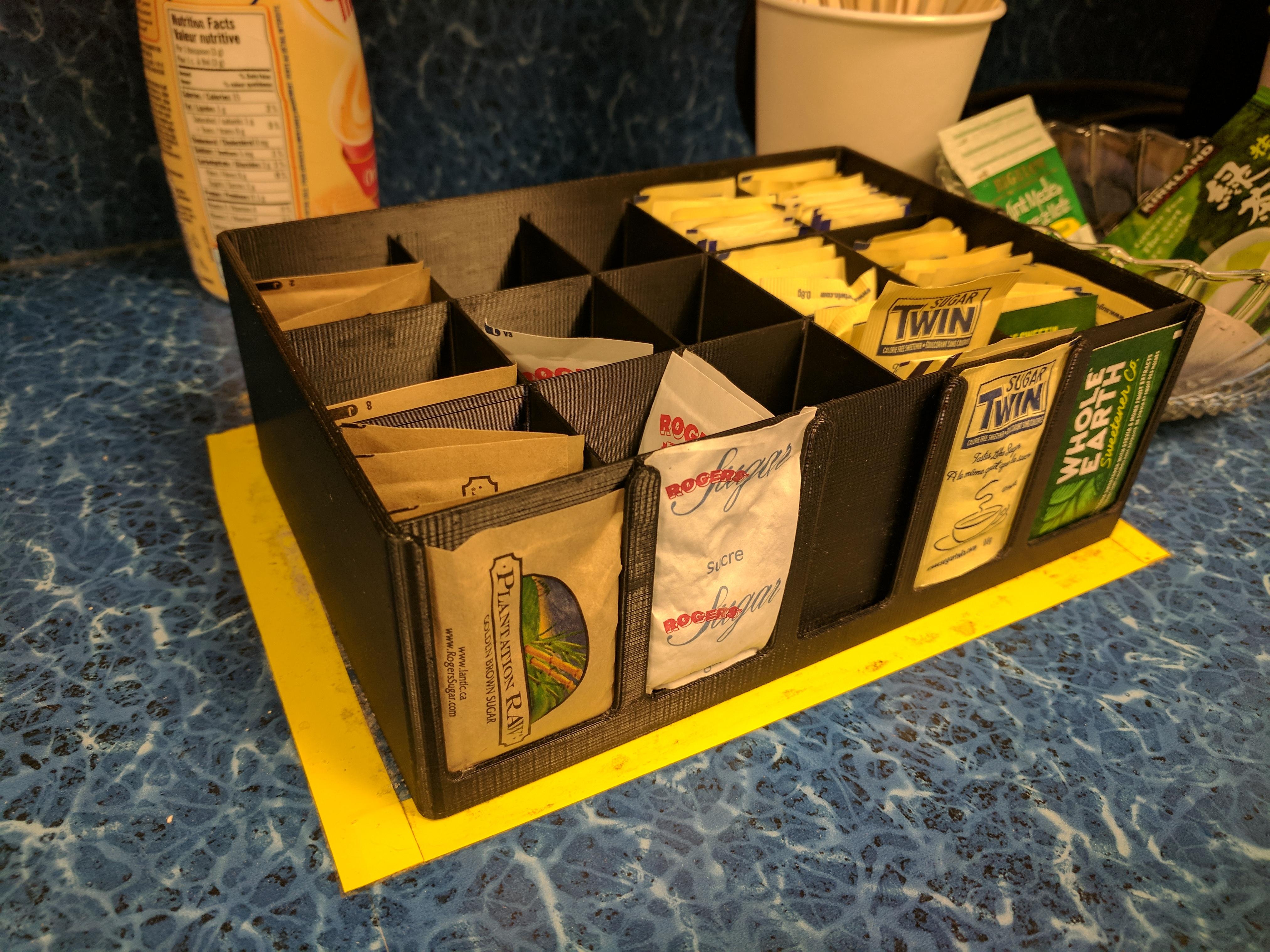 Sugar packet holder for the breakroom with a single display slot in