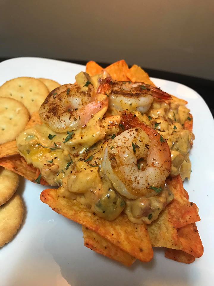 Cheesy seafood dip on bed of nacho Doritos with a side of Ritz crackers