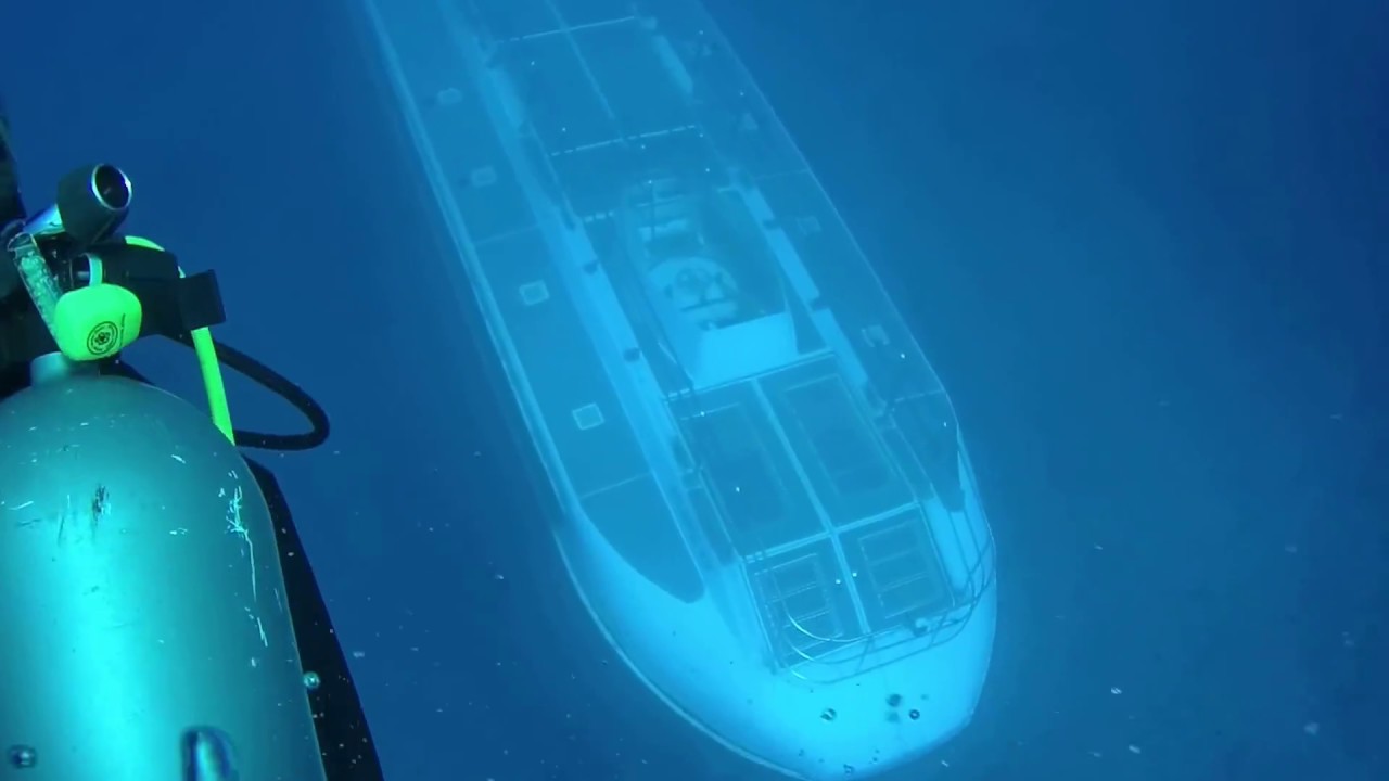 submarine ascends from the depths right under divers submechanophobia