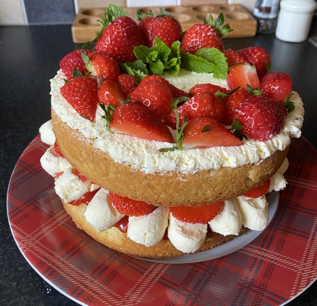 Homemade Victoria Sponge Cake with fresh strawberries, whipped cream