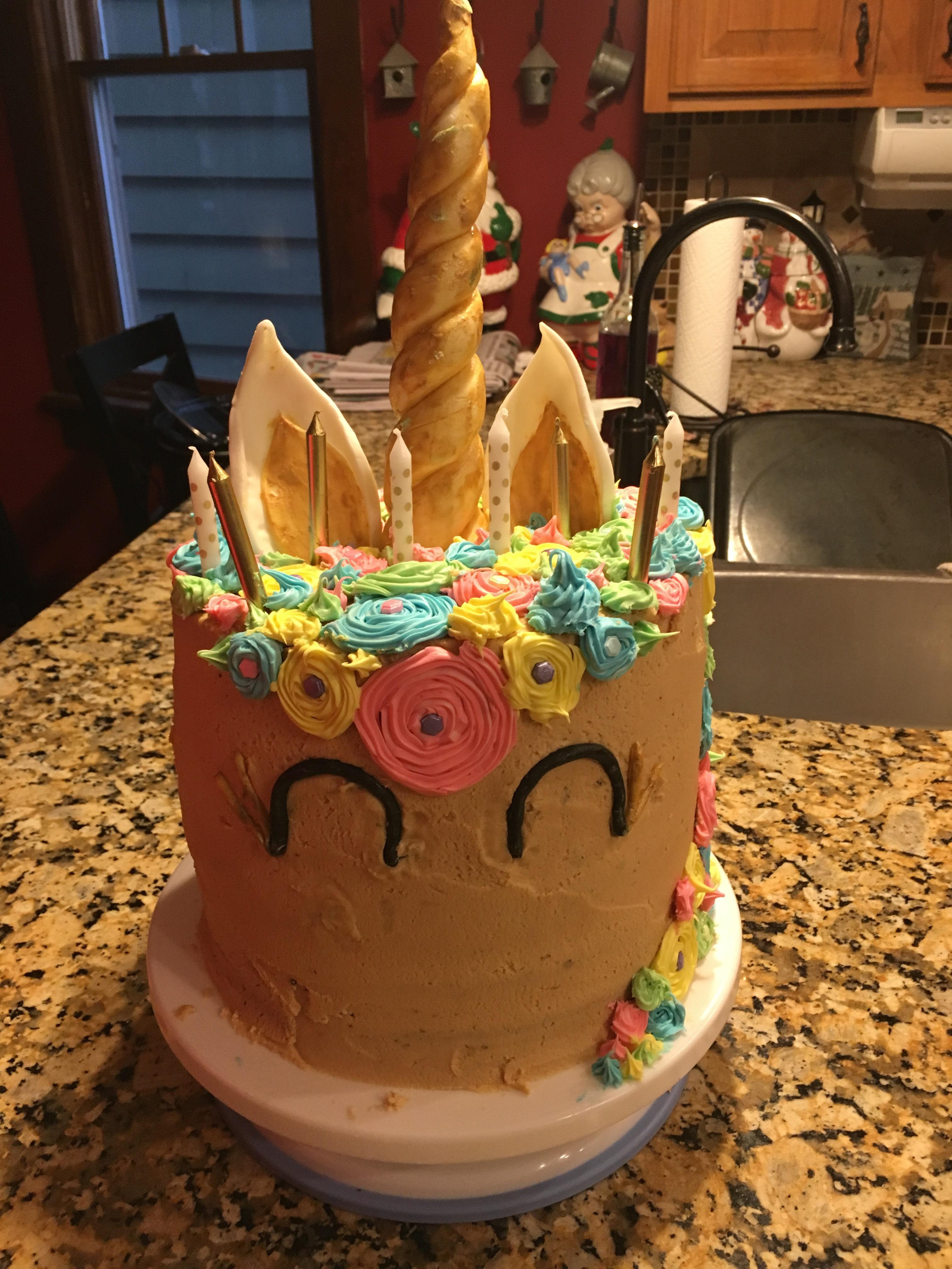 Chocolate cake, peanut butter icing unicorn. First attempt at working with fondant as well as a