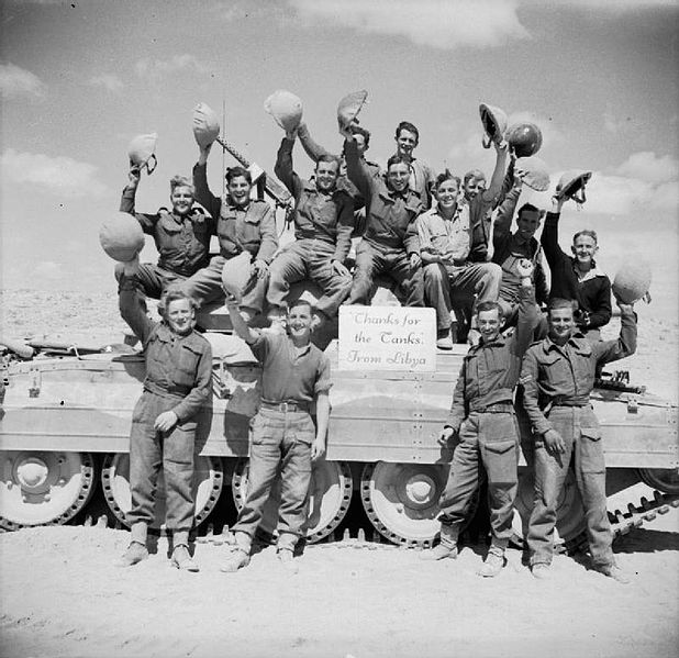 Cheering crews pose with a Crusader tank for a special photograph to