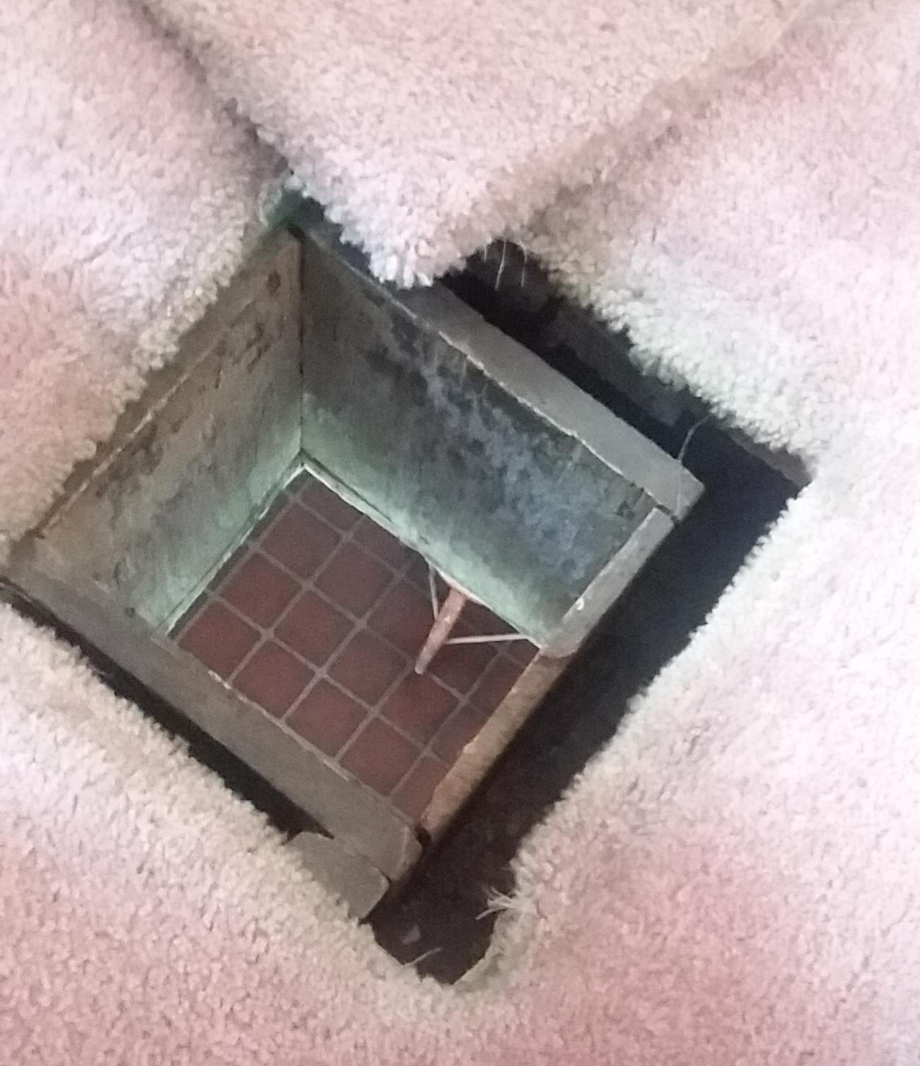 A Hole in the floor of the room I'm staying in goes right down to the