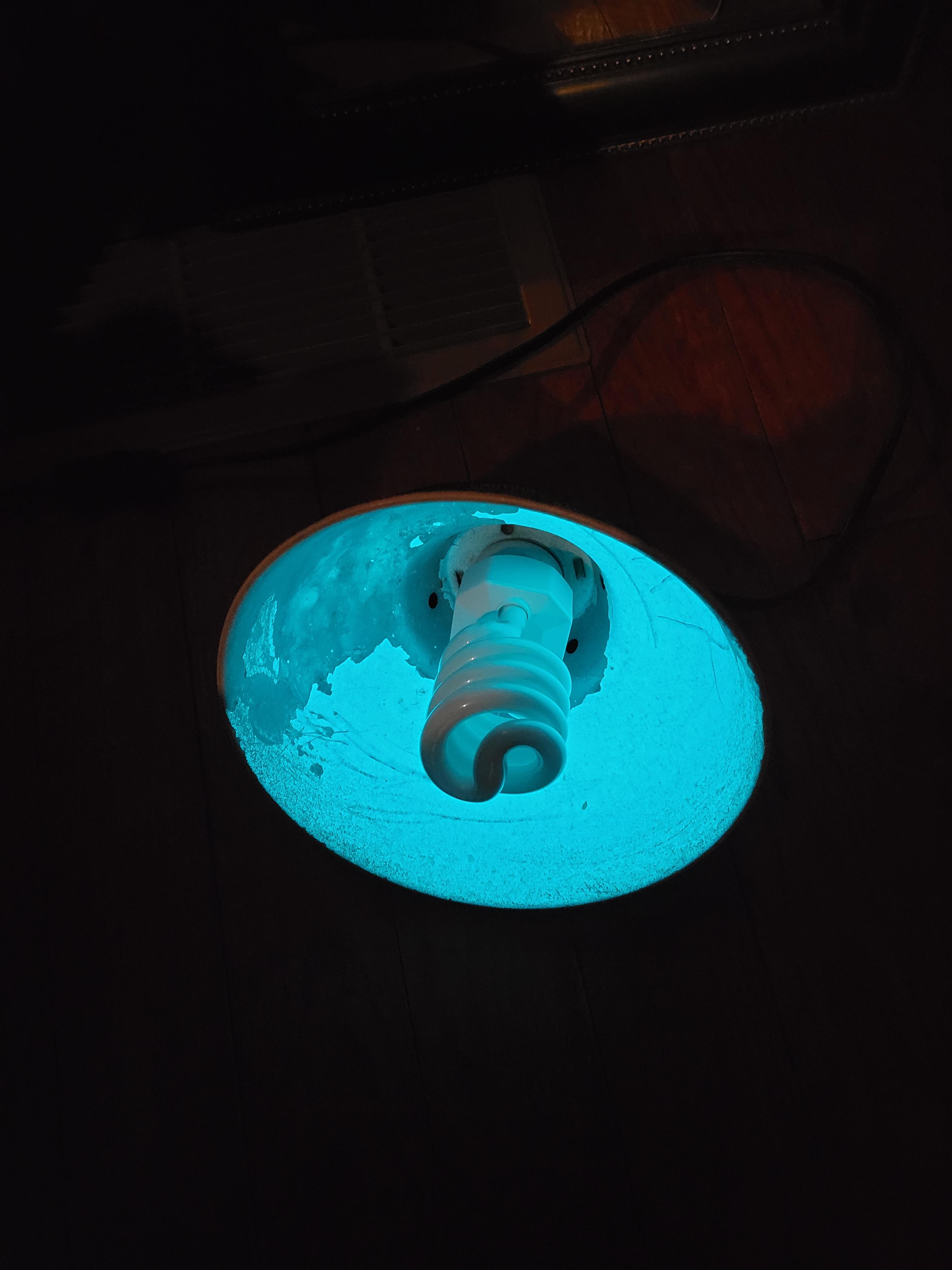 The limescale buildup in my aquarium lamp glows when exposed to UV r