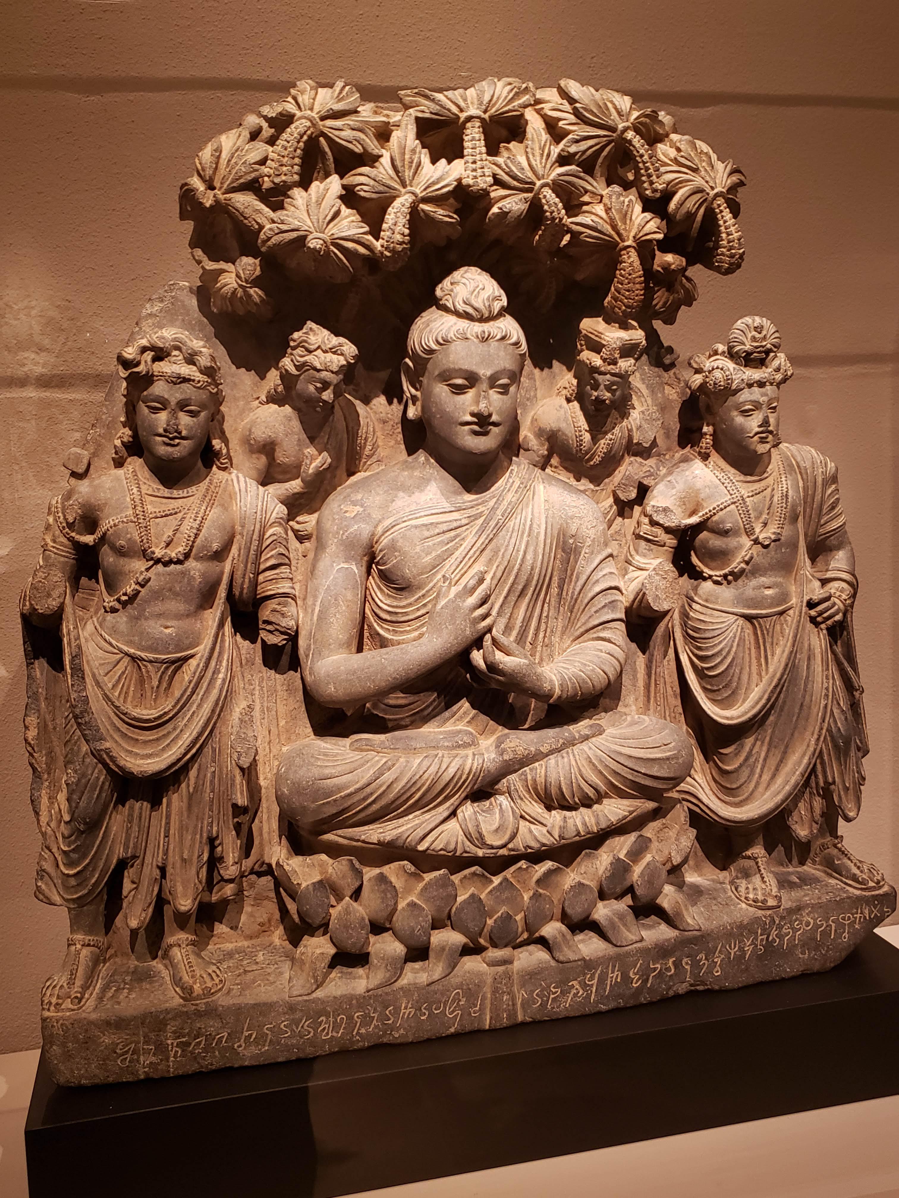 Sculpture of Buddha Shakyamuni attended by boddhisavtas under a tree