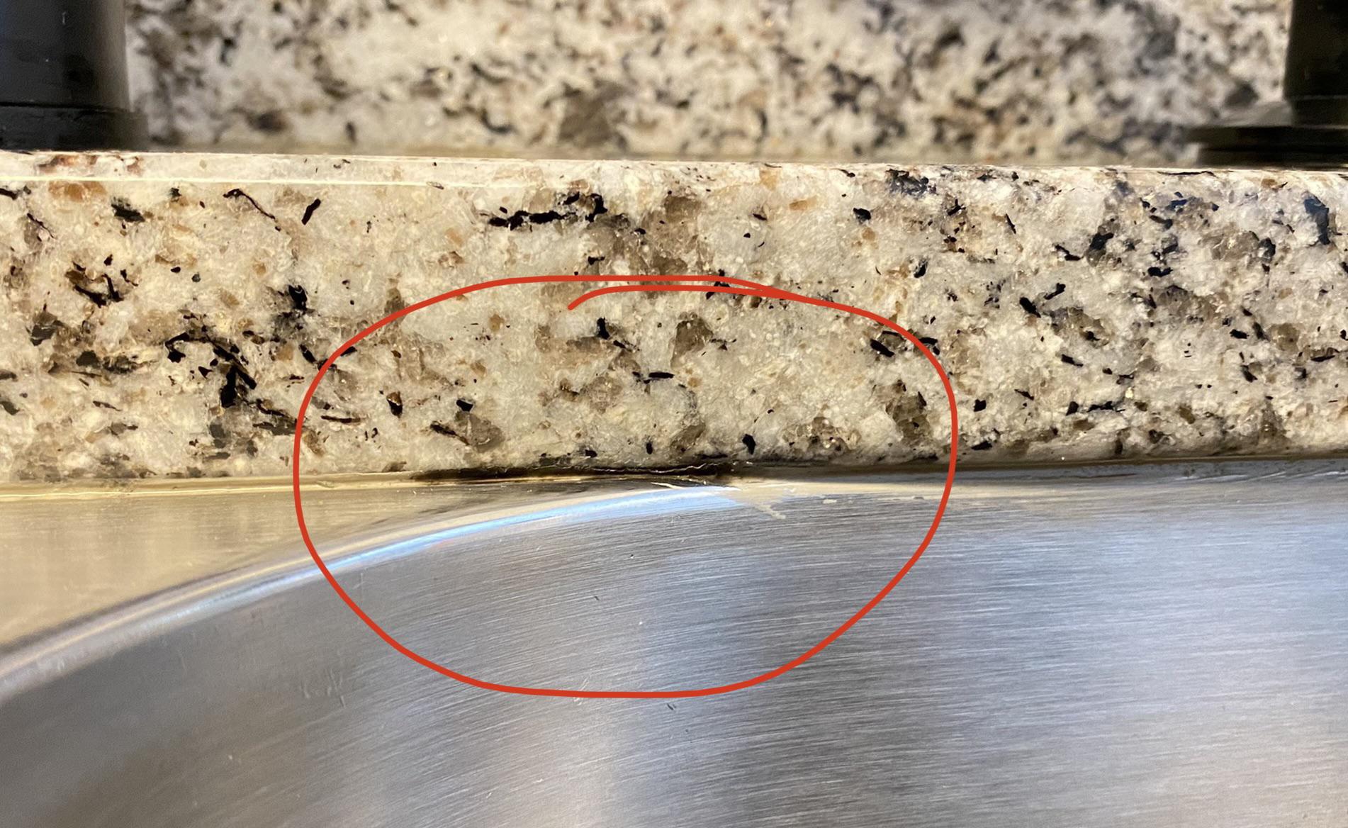 Adhesive between sink and granite is coming of. What kind of glue or