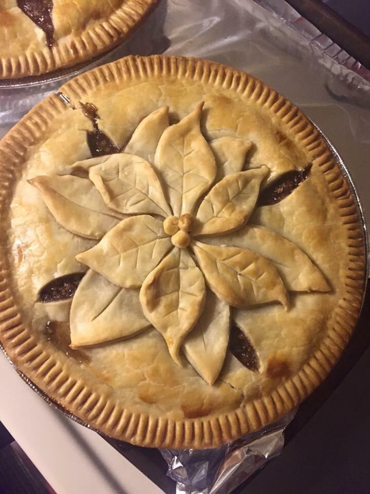 Homemade mincemeat pie with hand cut poinsettia decoration. [720x960