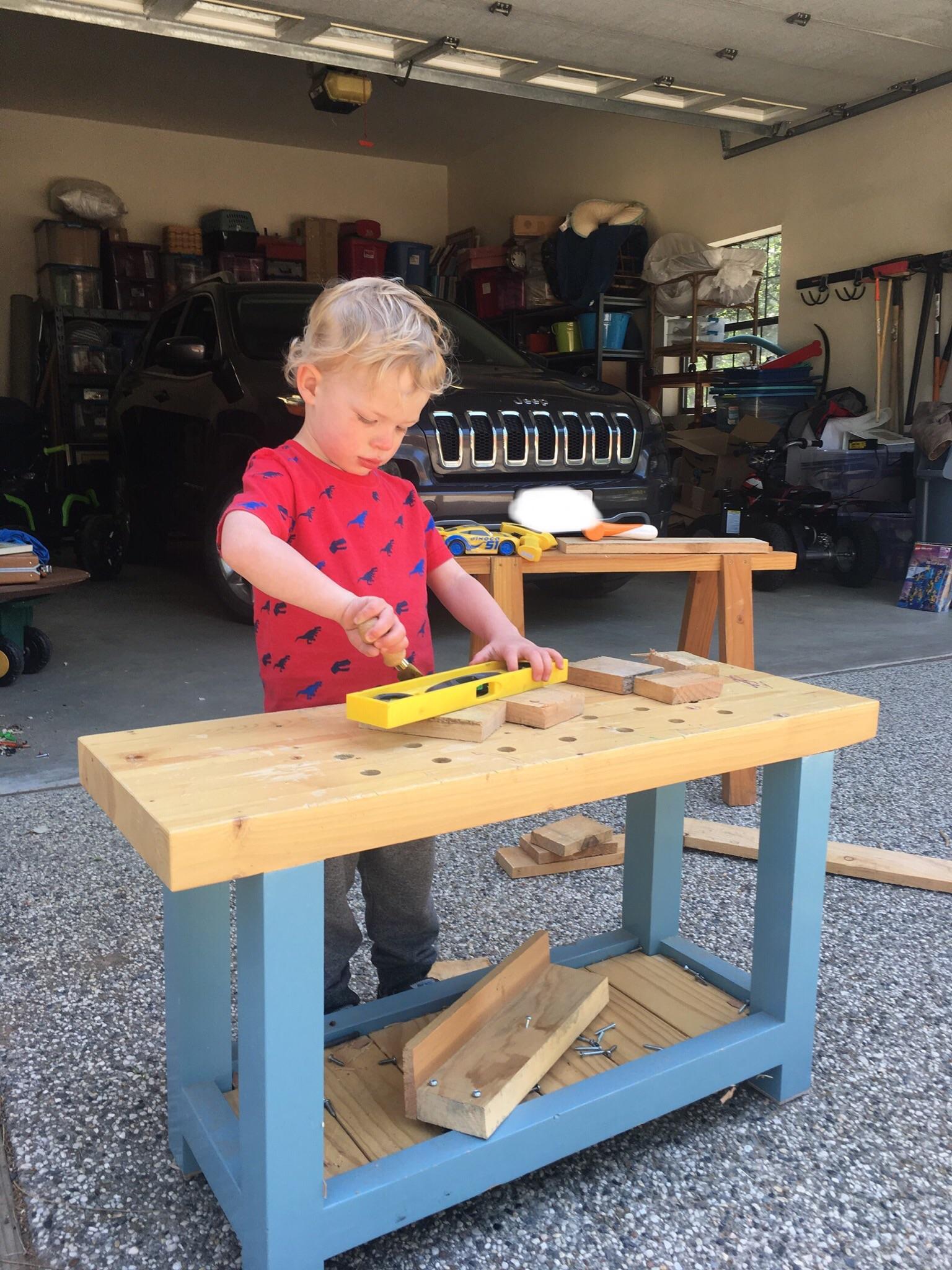 Working on his tiny bench, it doubles as an overbuilt sit down bench to