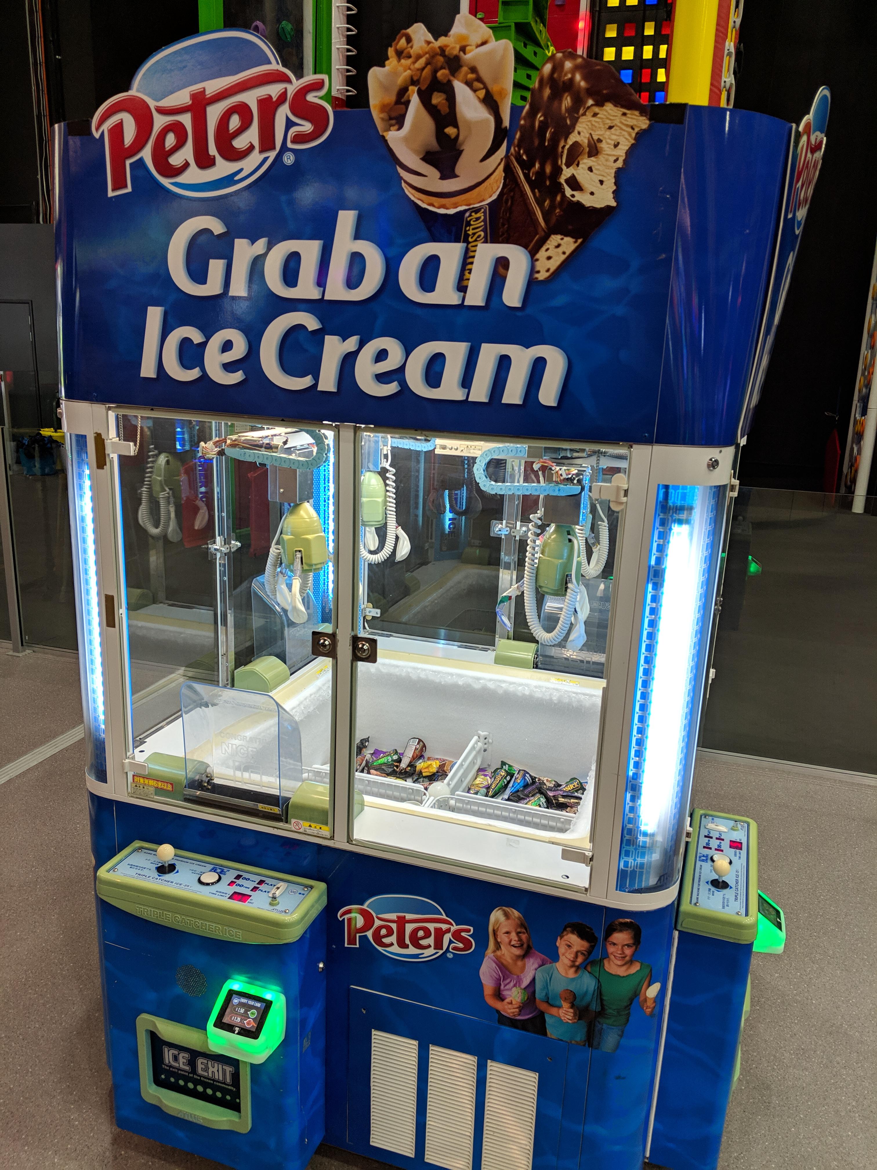A claw machine game where you try to win ice cream mildlyinteresting
