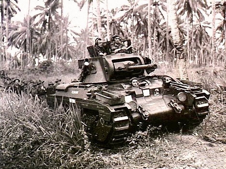 A Matilda tank, named "Clincher", moves towards Japanese strong points