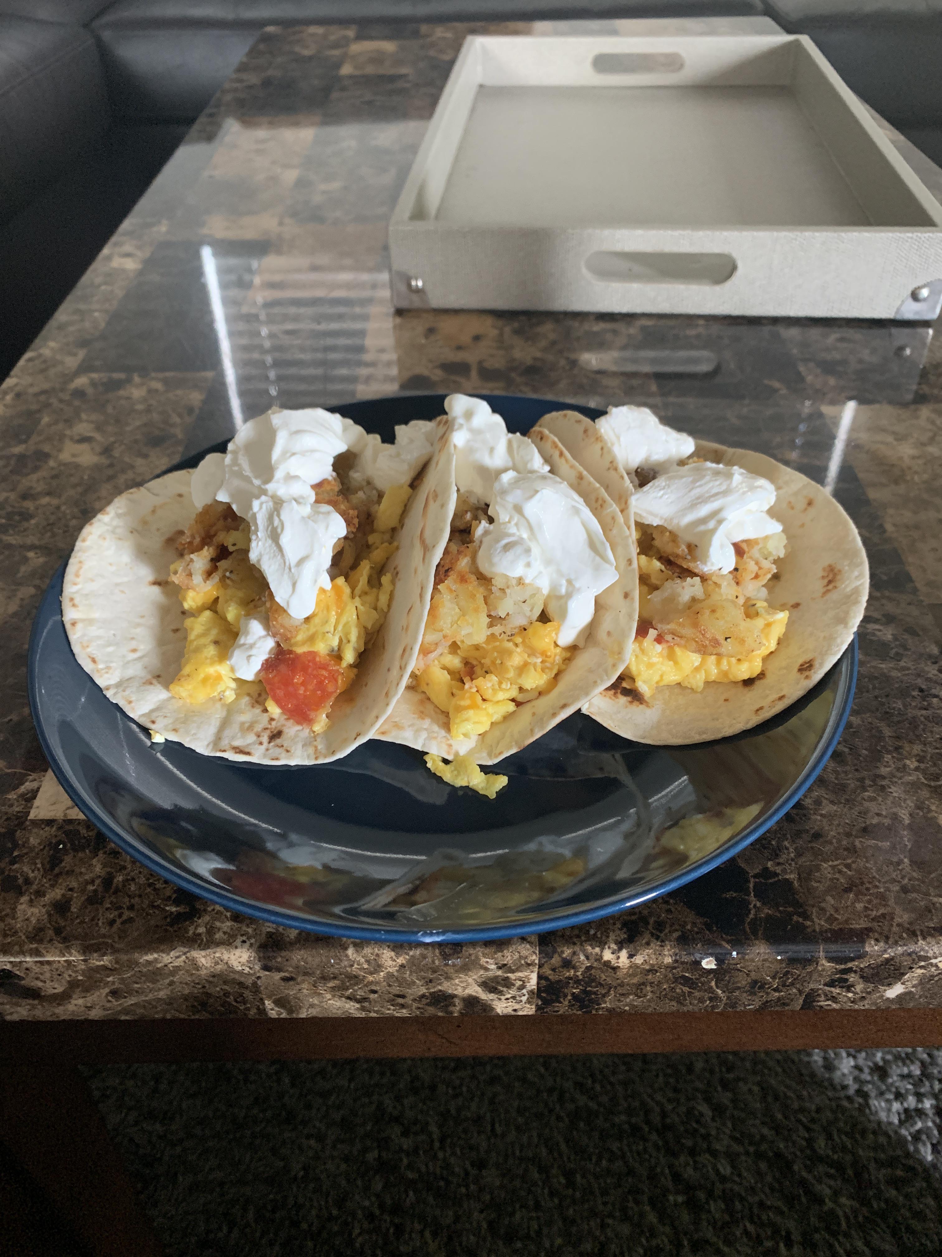 Pepperoni egg and cheese breakfast tacos with sour cream. Simple