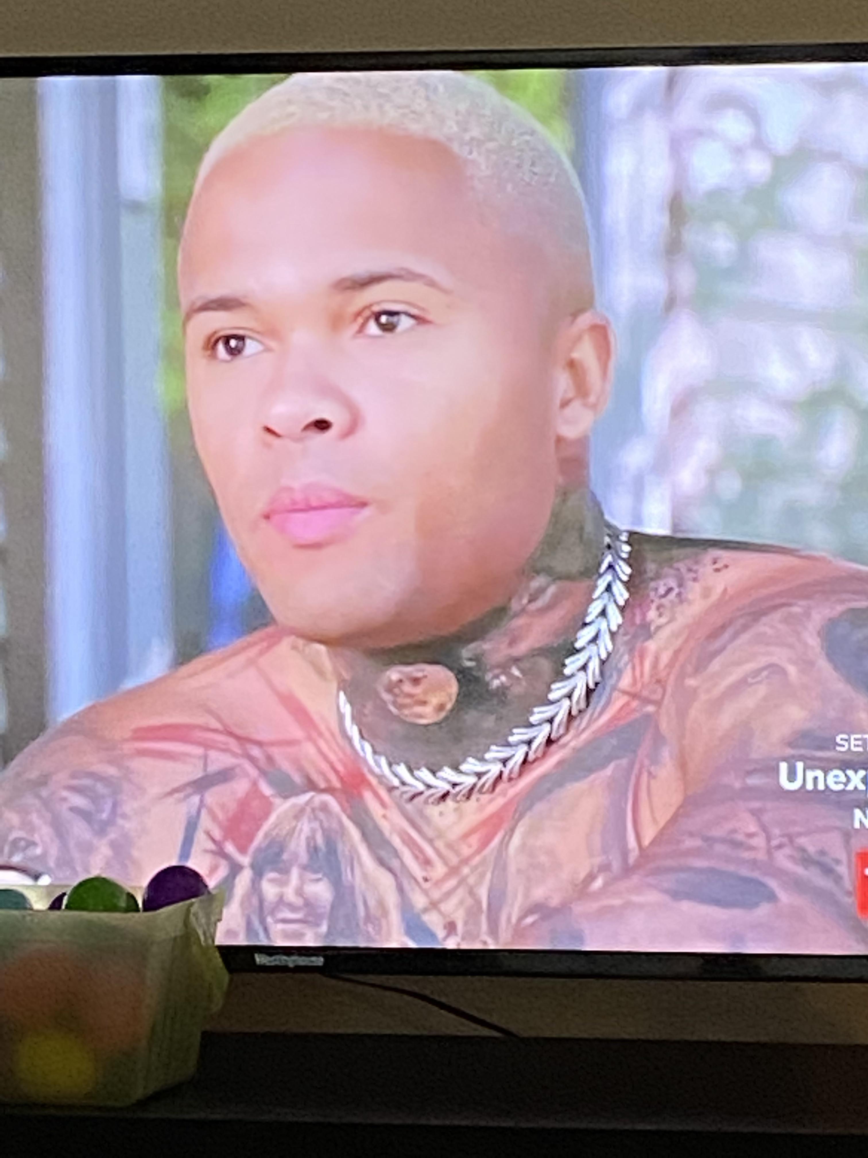 Why is this grown man wearing a dog collar made out of spoon handles