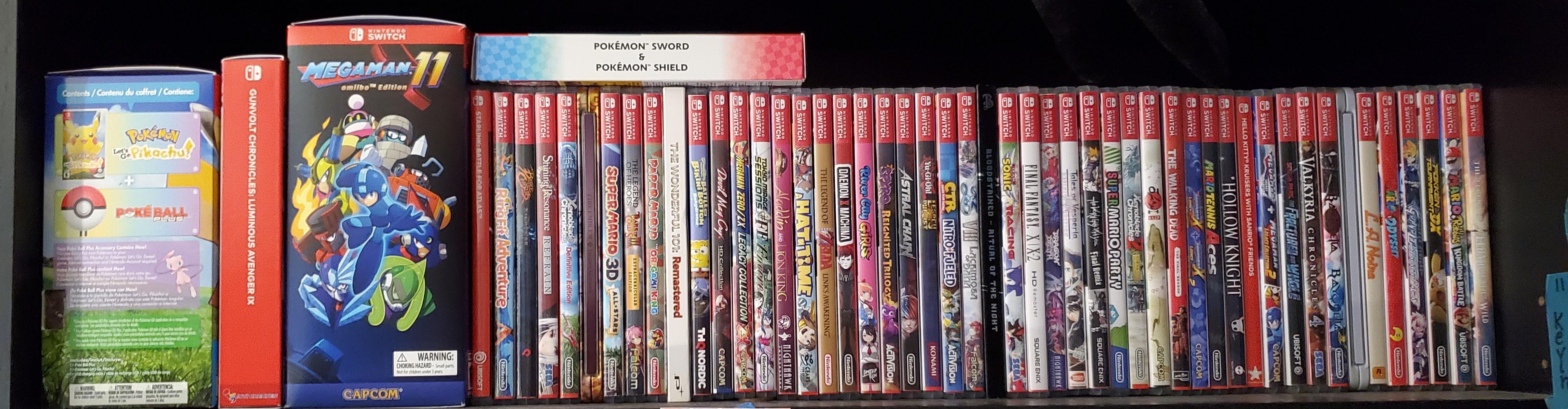 Well top shelf filled with Switch games, with spines thanks to Switch spines subreddit. r