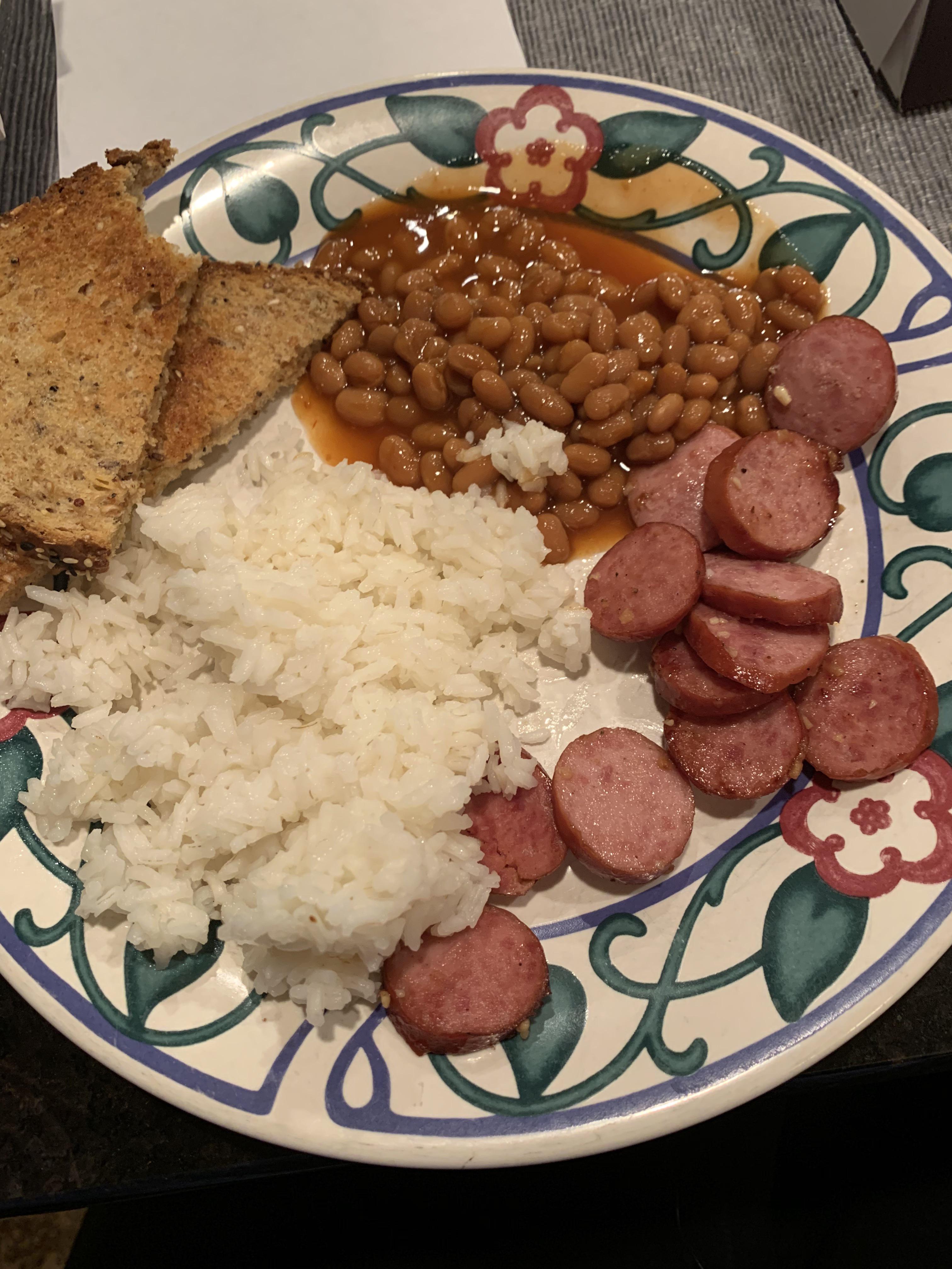 Kielbasa sausage, garlic butter rice, vegetarian baked beans and garlic