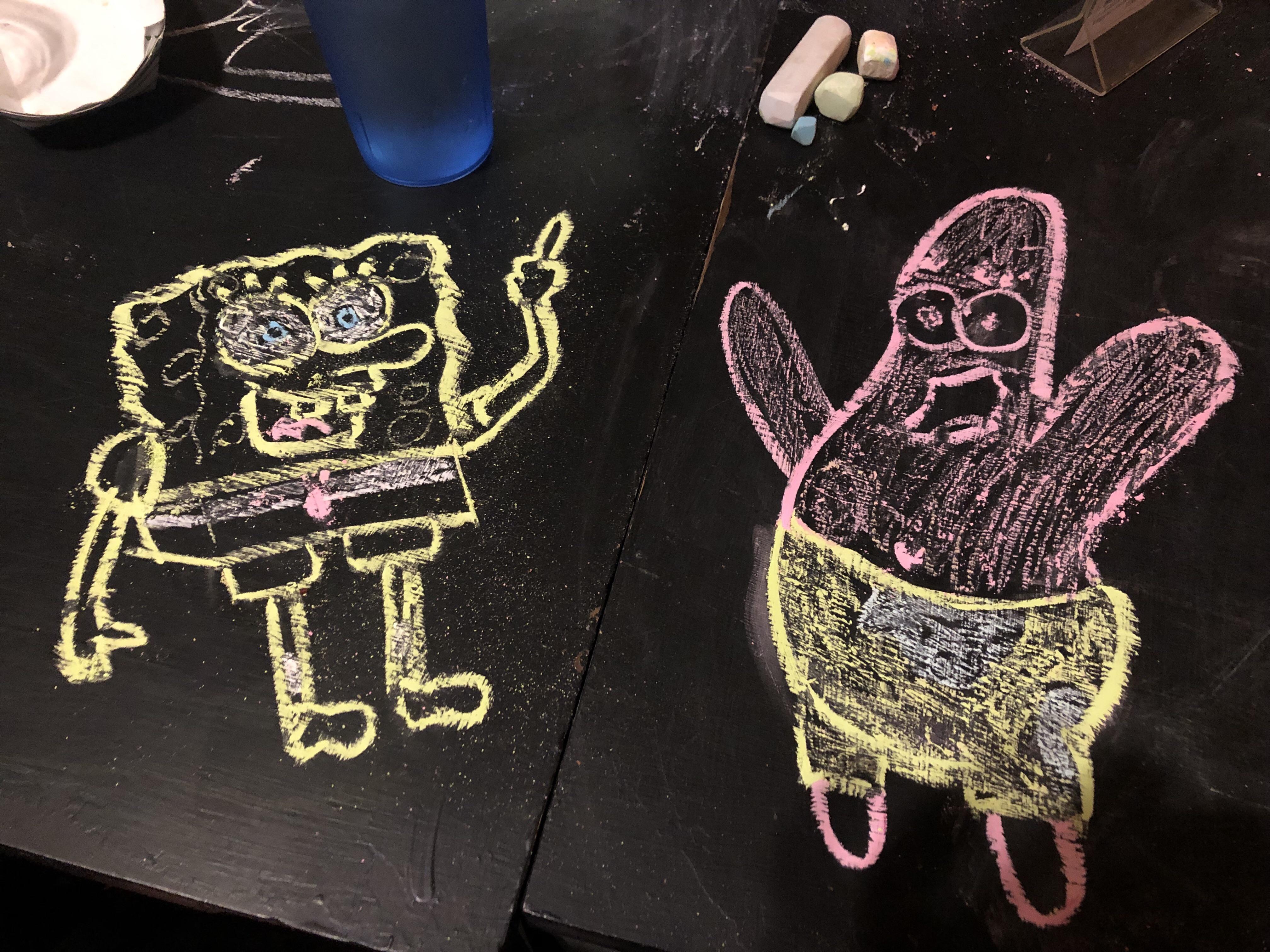 I drew spongebob and patrick with chalk on a table at a restaurant r