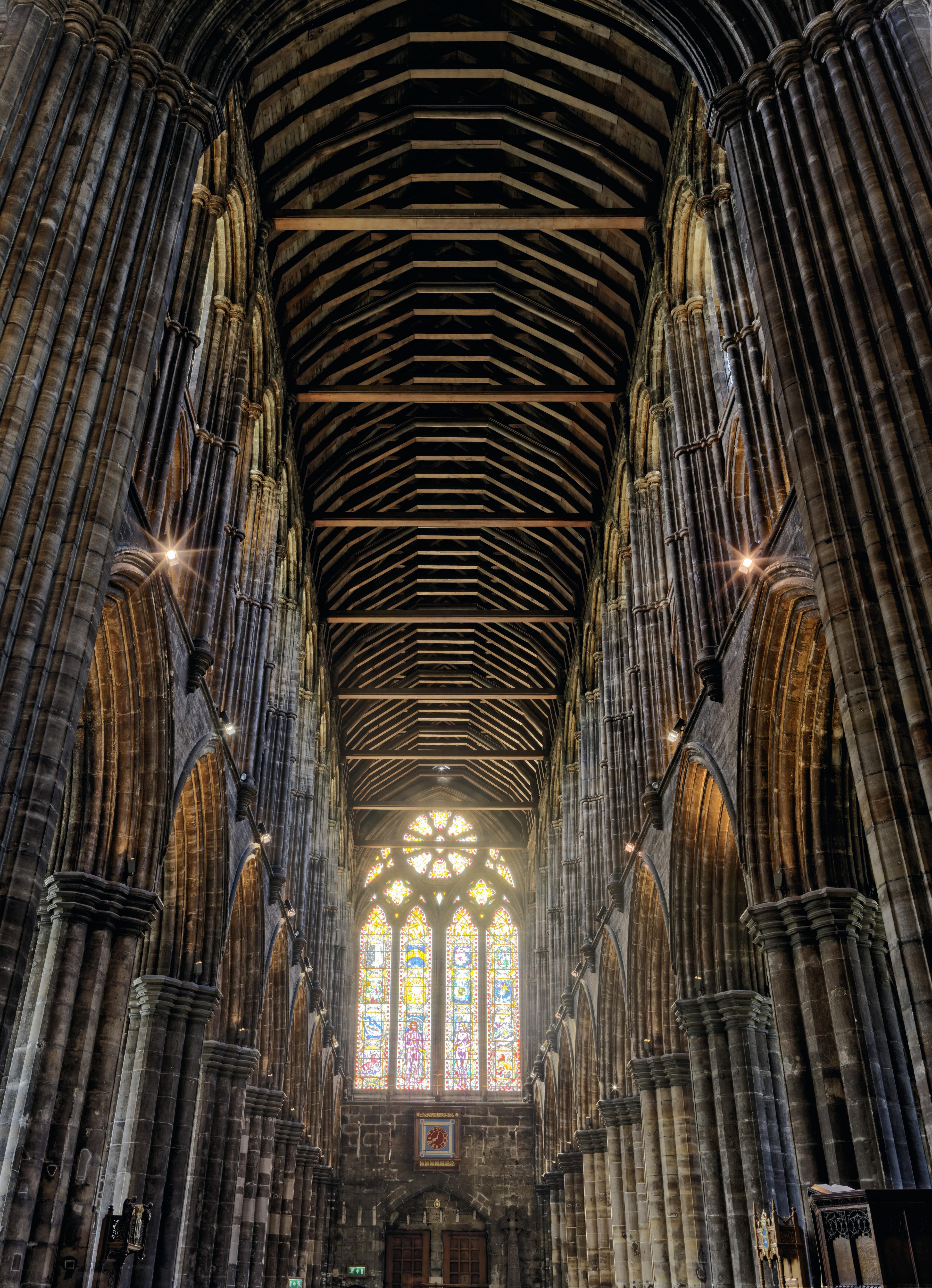 Stone arches, wood roof, stained glass window of Glasgow Cathedral [OC