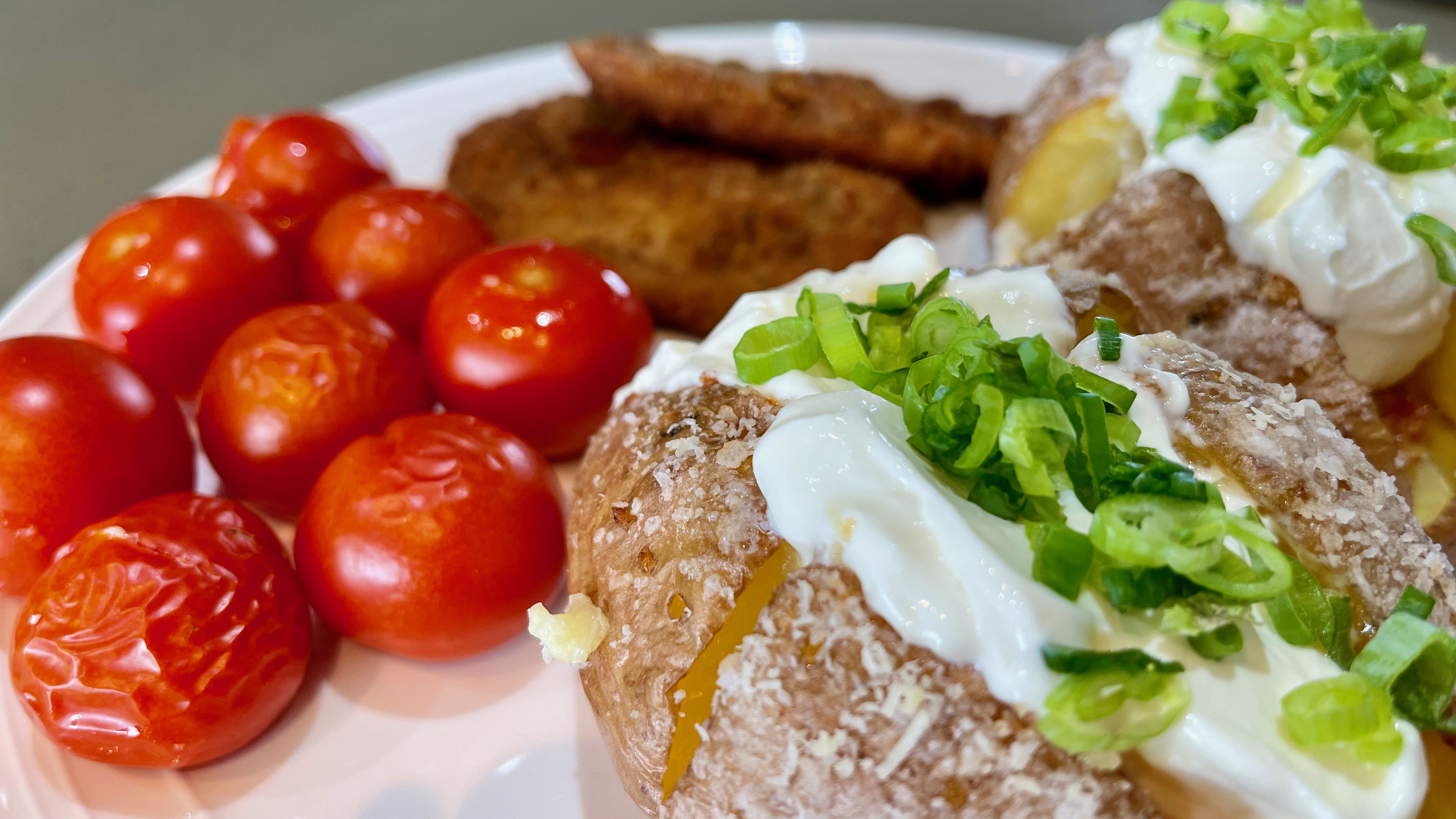 Baked potatoes stuffed with ham, parmesan cheese and sour cream, served