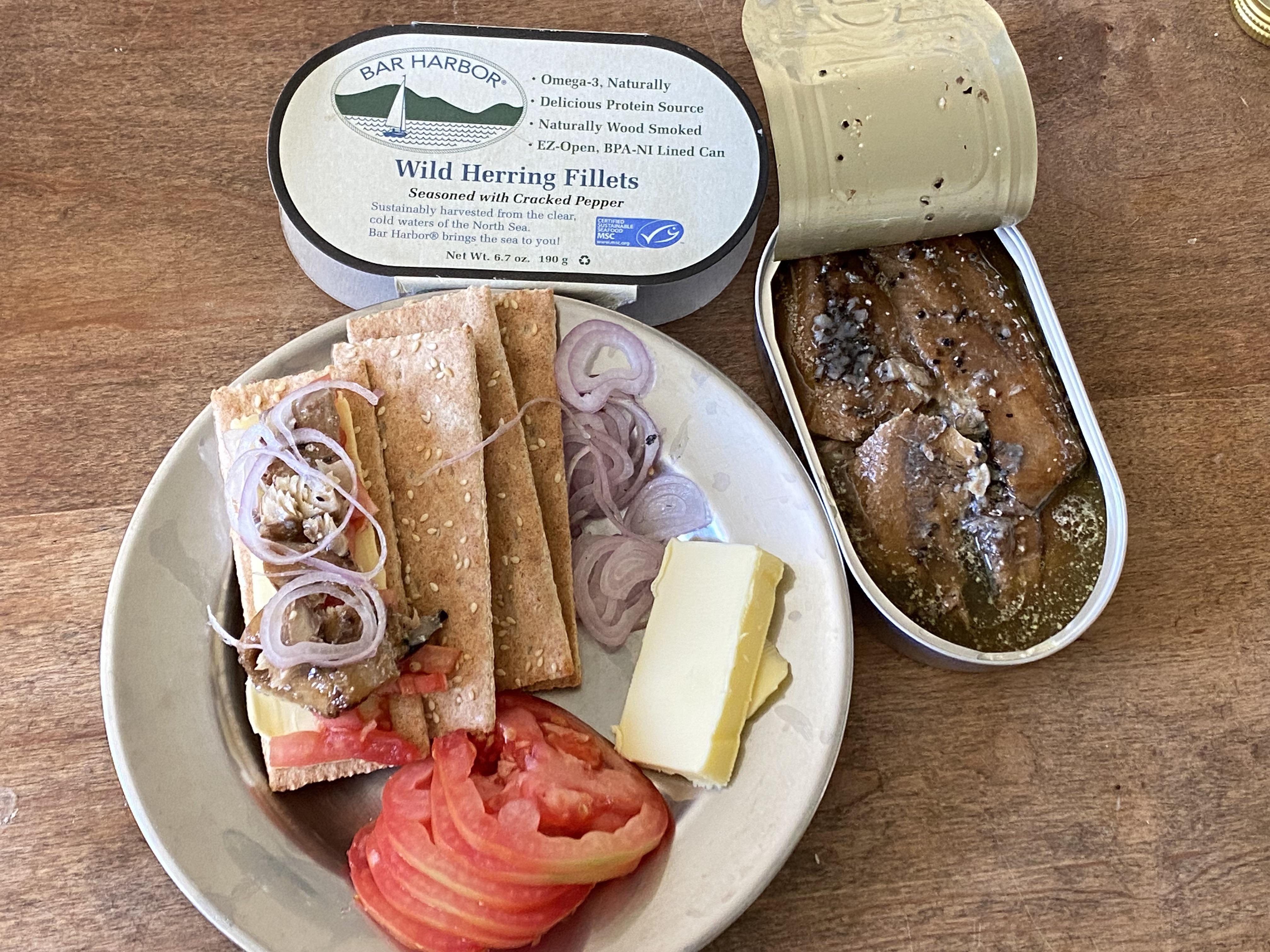 Tinned herring for lunch with buttered crackers and tomatoes and