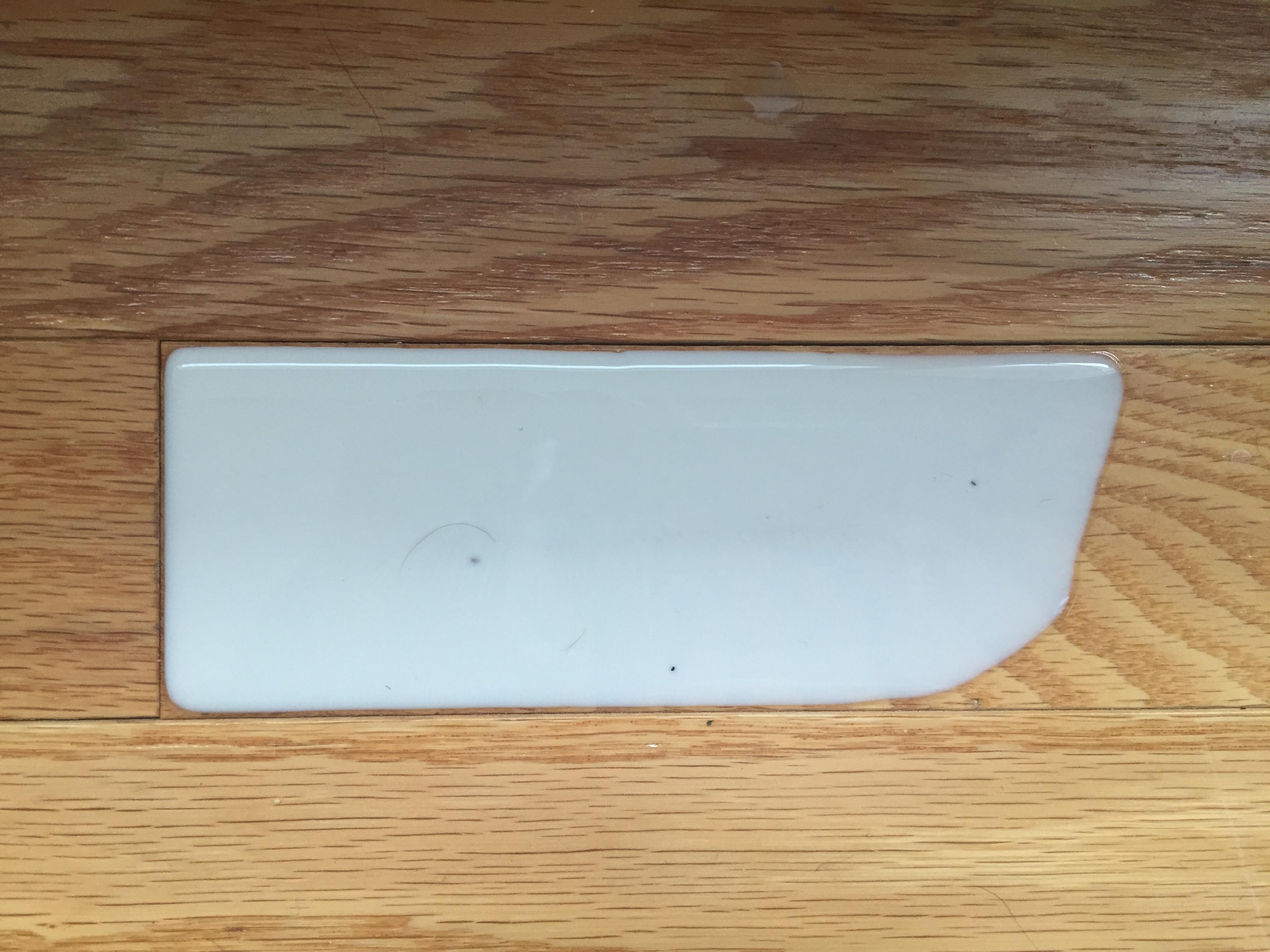 The way this spilled milk collected on a hardwood plank r