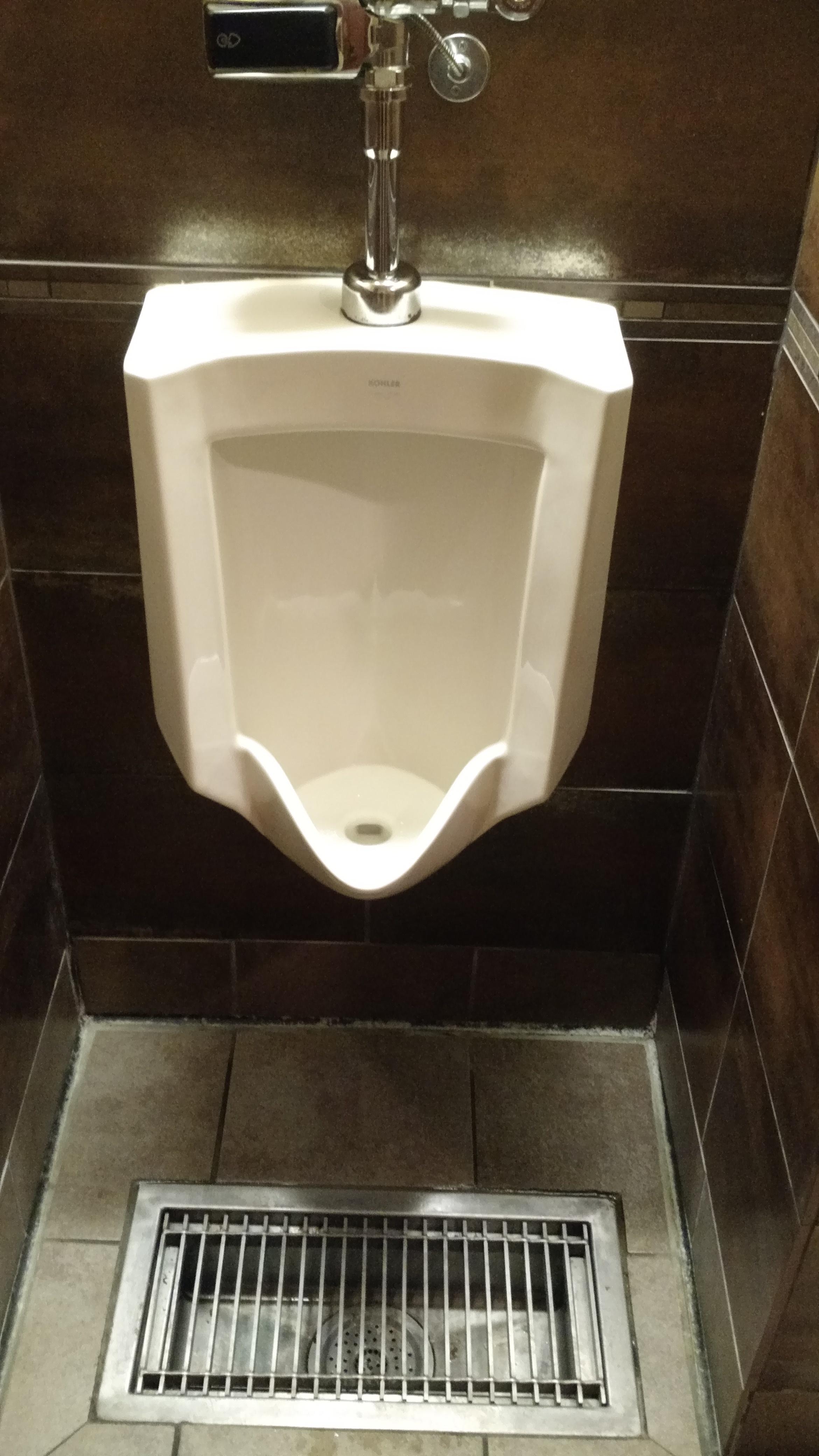 This urinal has a drain at the bottom to collect the final dribbles