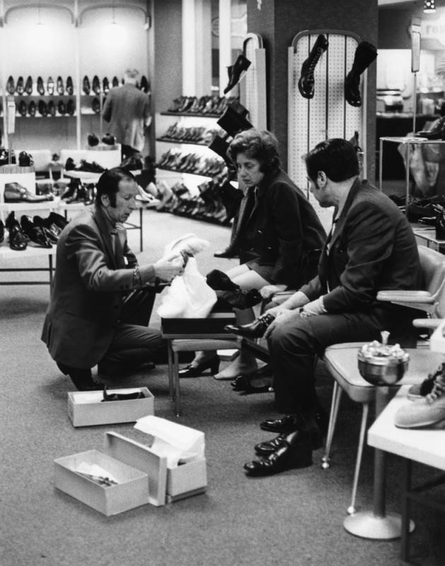 Customers examine shoes in the men's shoe department in an unidentified