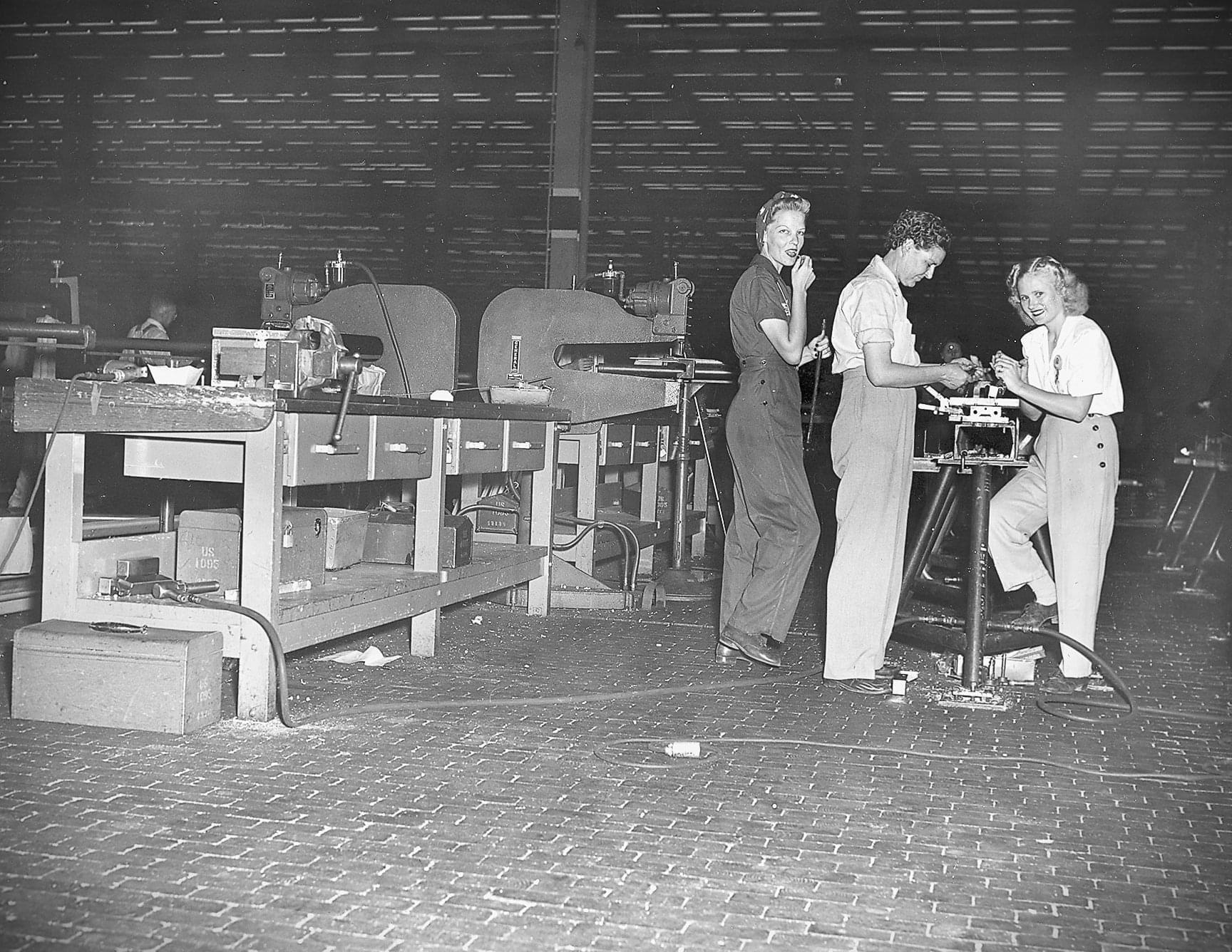"The Ladies of Bell Bomber" Three female employees smile for the