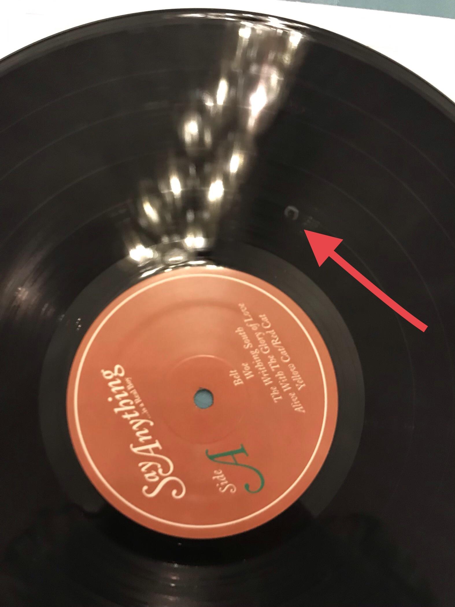 Crappy record player left rubber marks on some of my albums. Tried