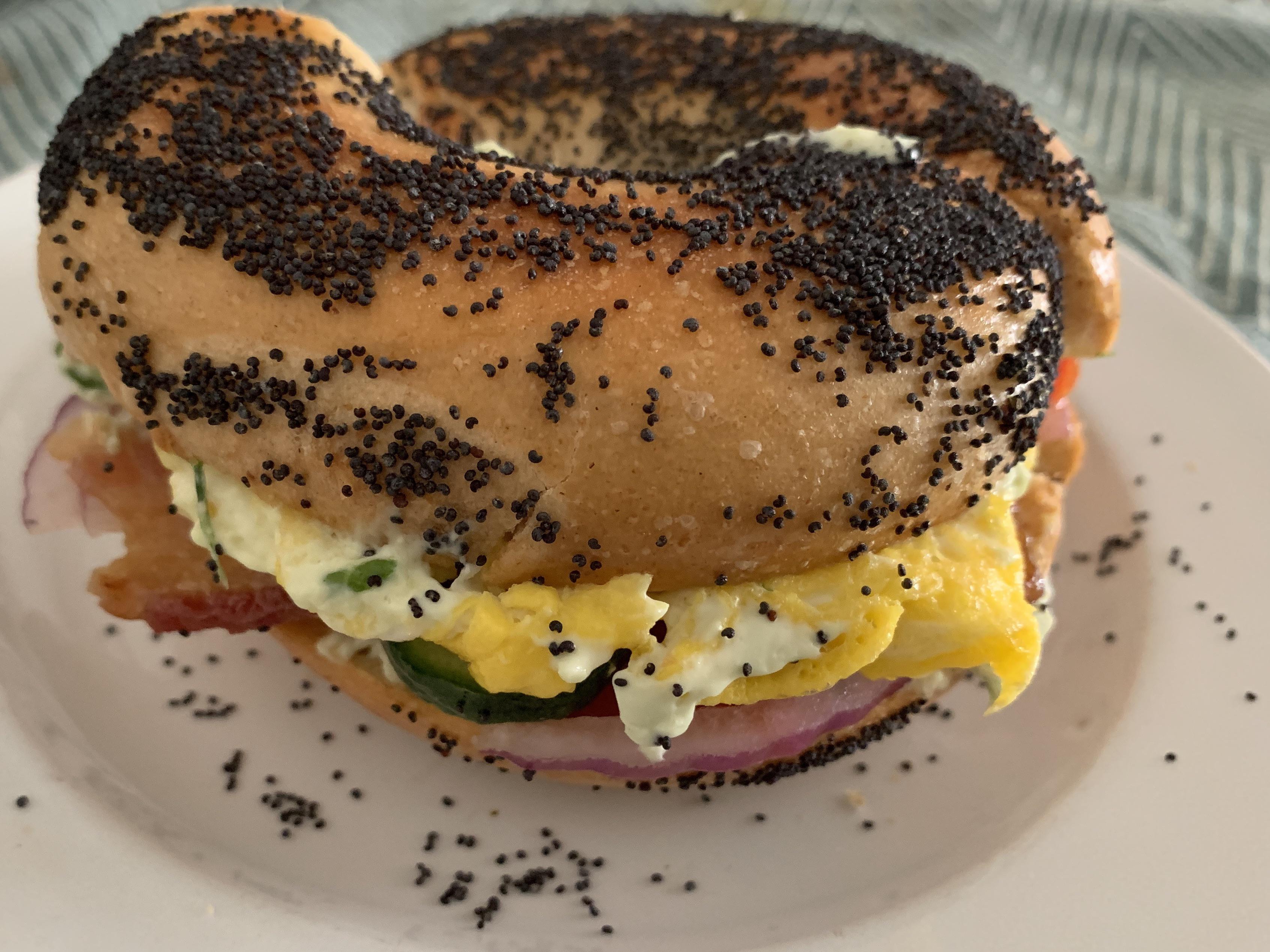 Breakfast sandwich bagel. Egg, chive cream cheese, bacon, tomato