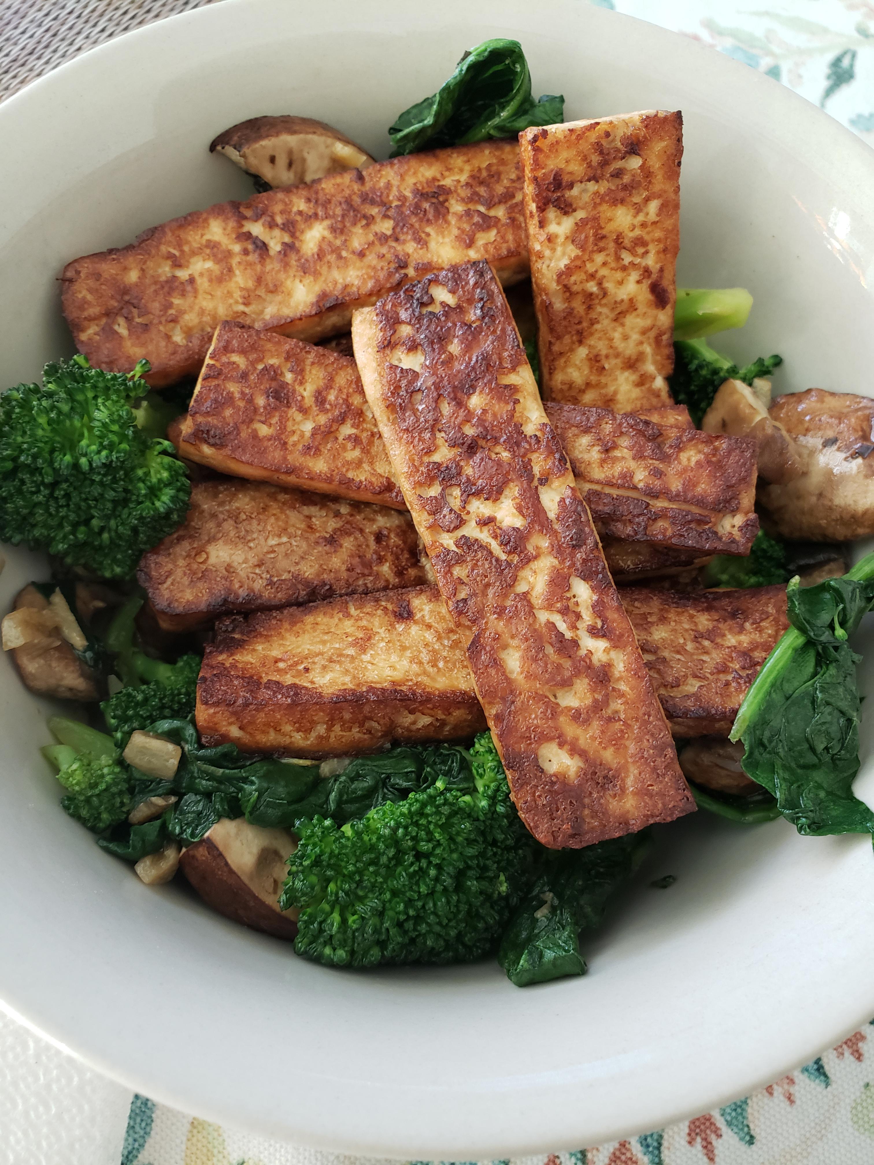 Grilled tofu over garlic baby portabella mushrooms, spinach, and