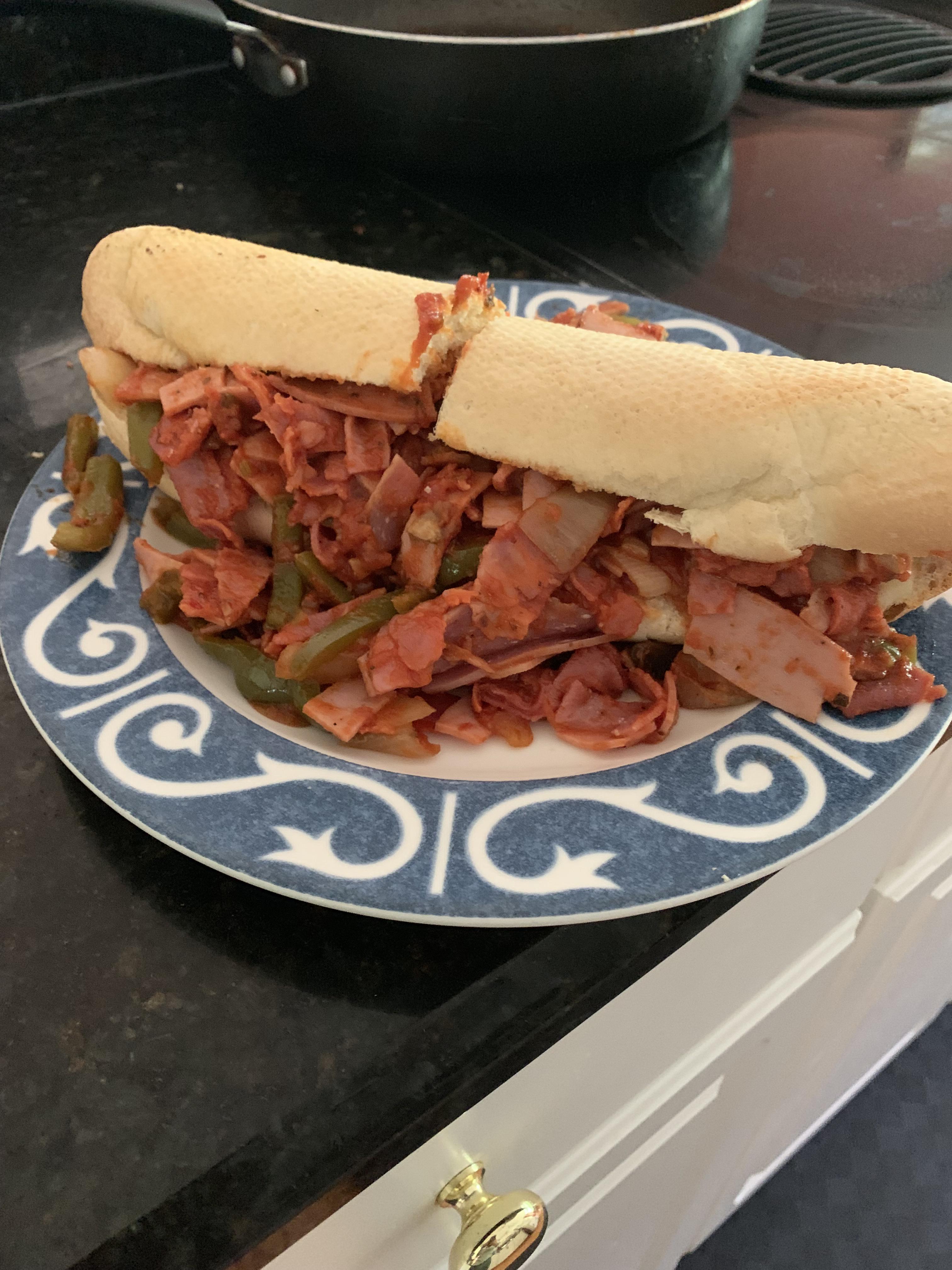 Pizza Sub hot capicola, pepperoni, salami, prosciutto, provolone, peppers, onions, house tomato