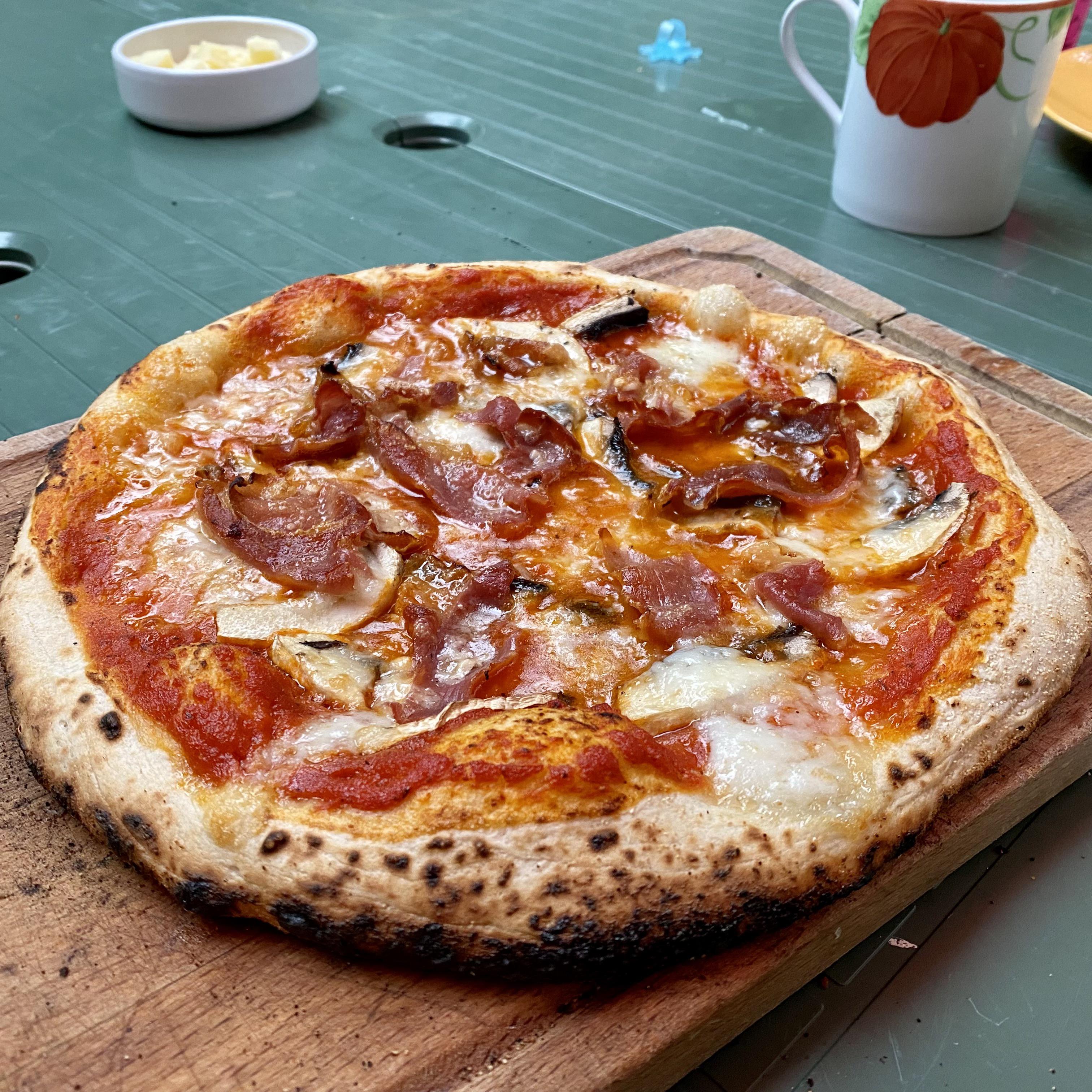 Prosciutto, mushroom, mozzarella and red sauce. Ooni for the win. r/ooni