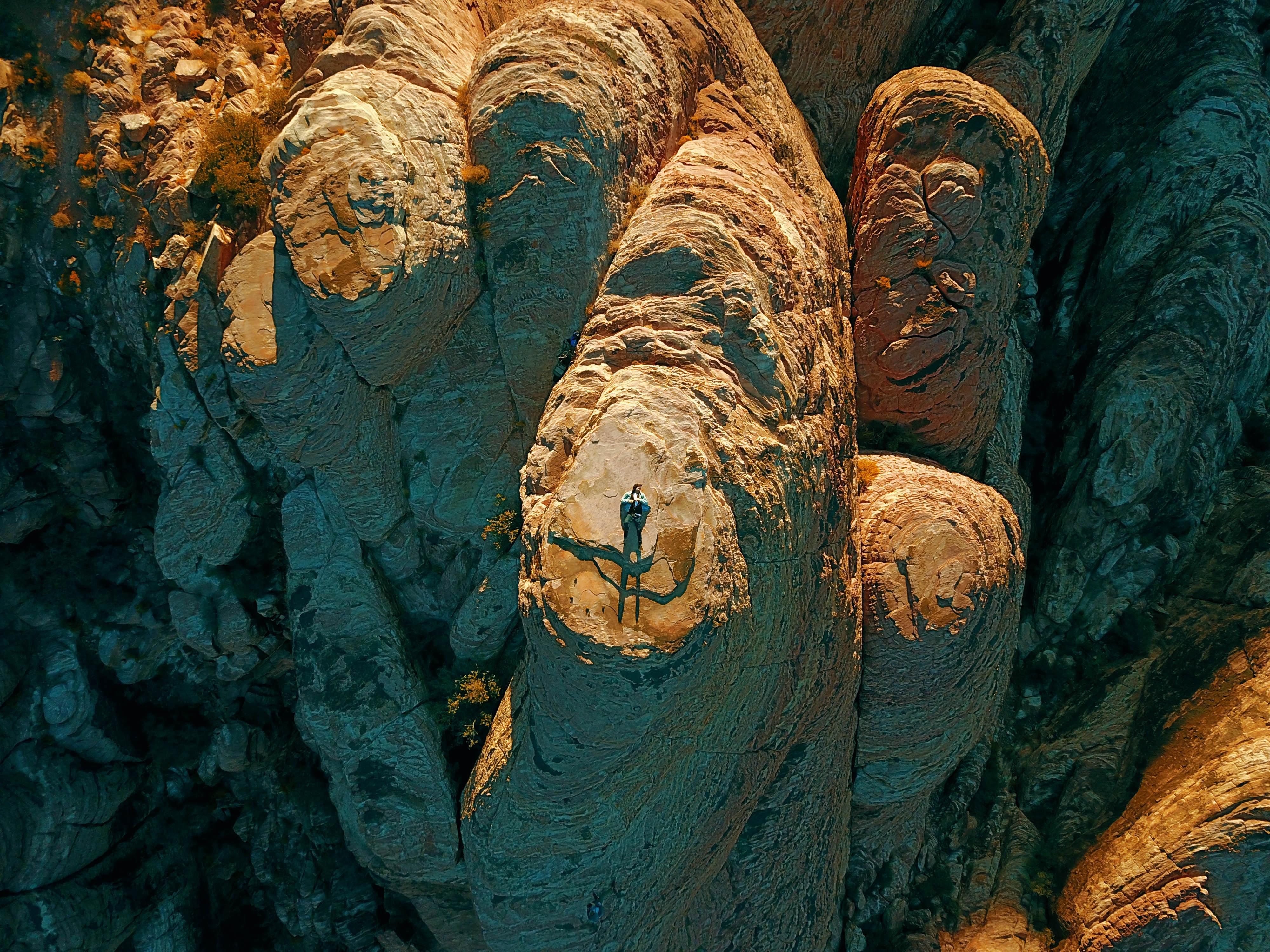 A photo of me laying on the top of a mountain taken by a drone. Red