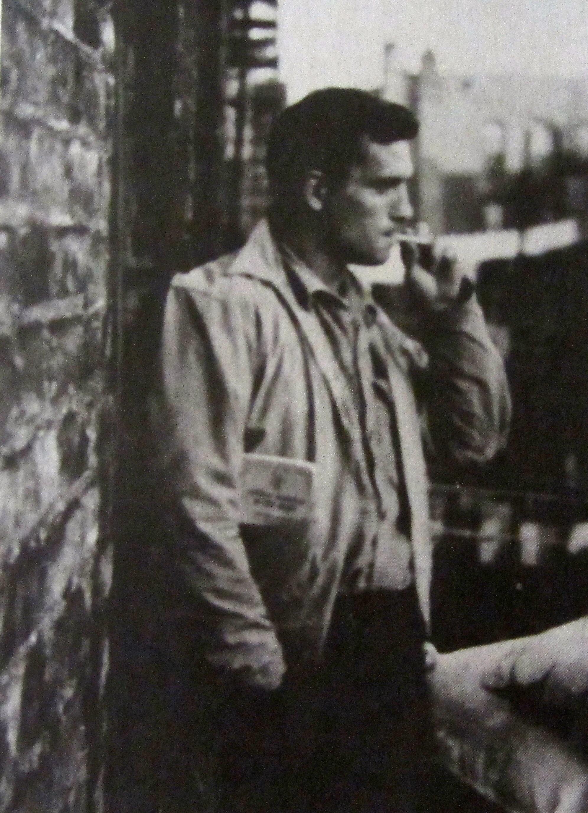 'On the Road' author, Jack Kerouac, smoking a cigarette on a NYC fire