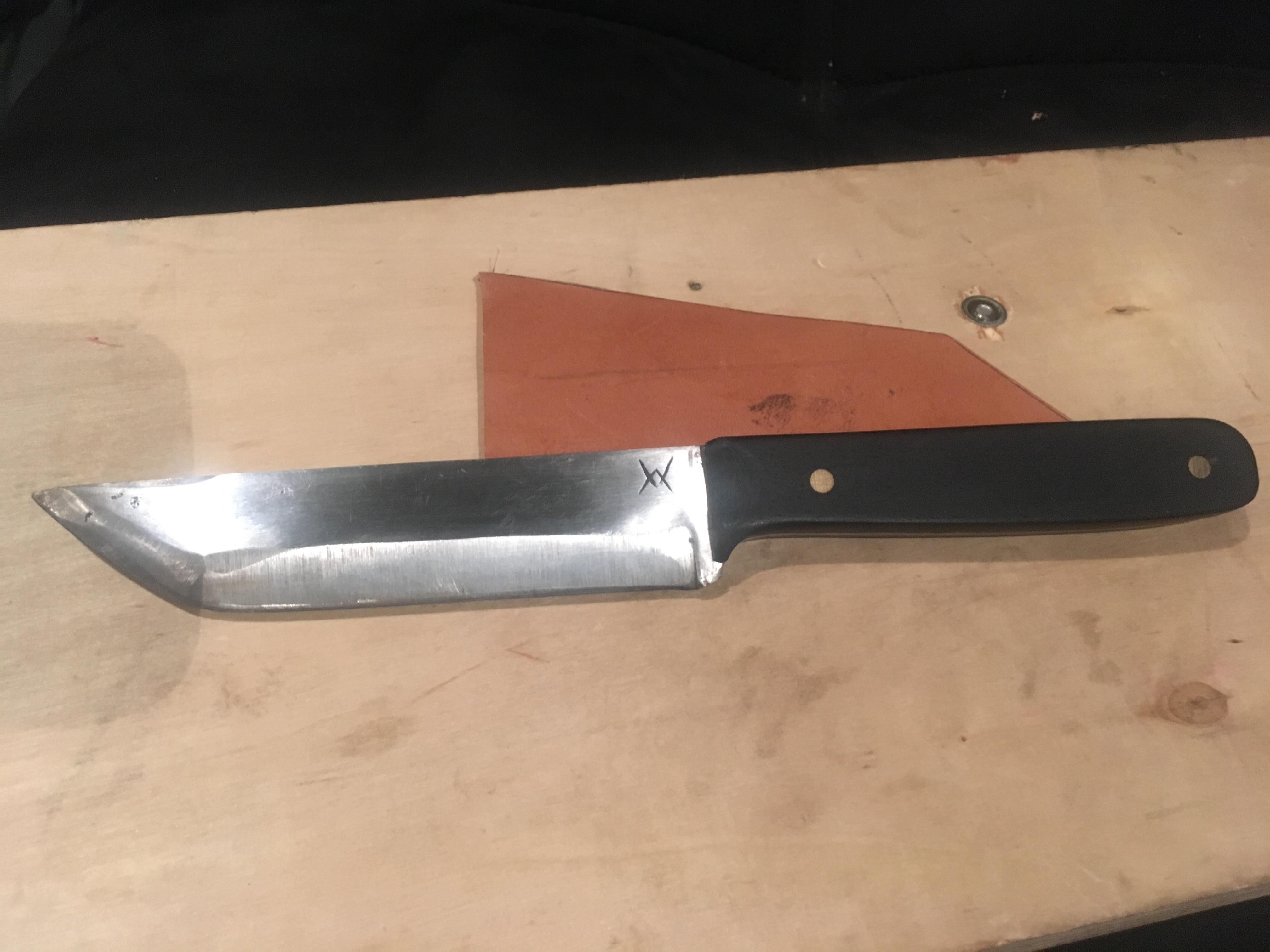 First finished knife. Coil spring and ebony wood. My own chiseled in