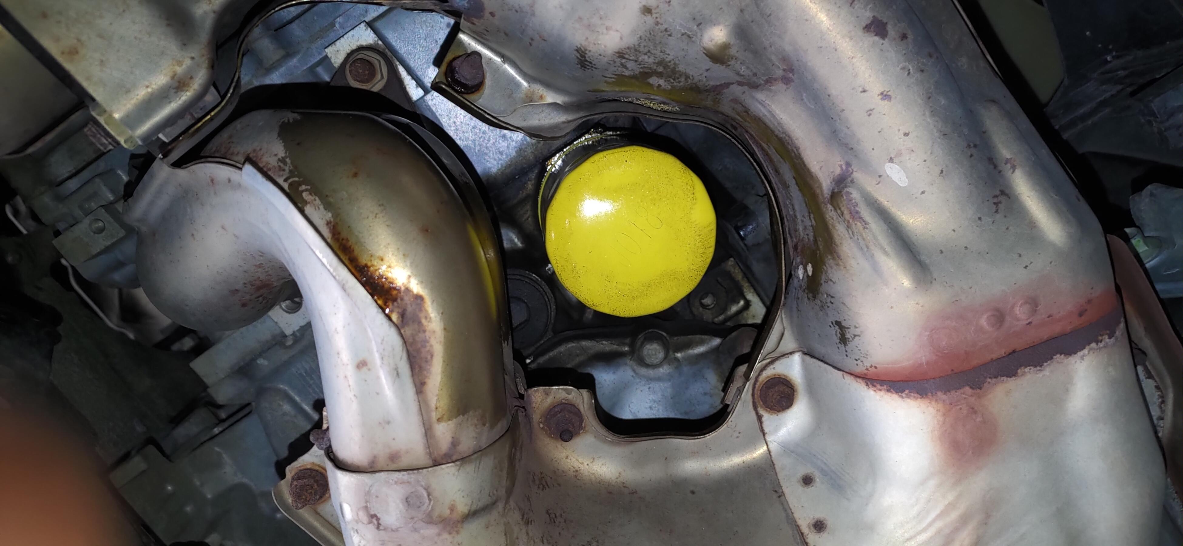 Subaru Outback oil filter surrounded by exhaust system. Talk about a