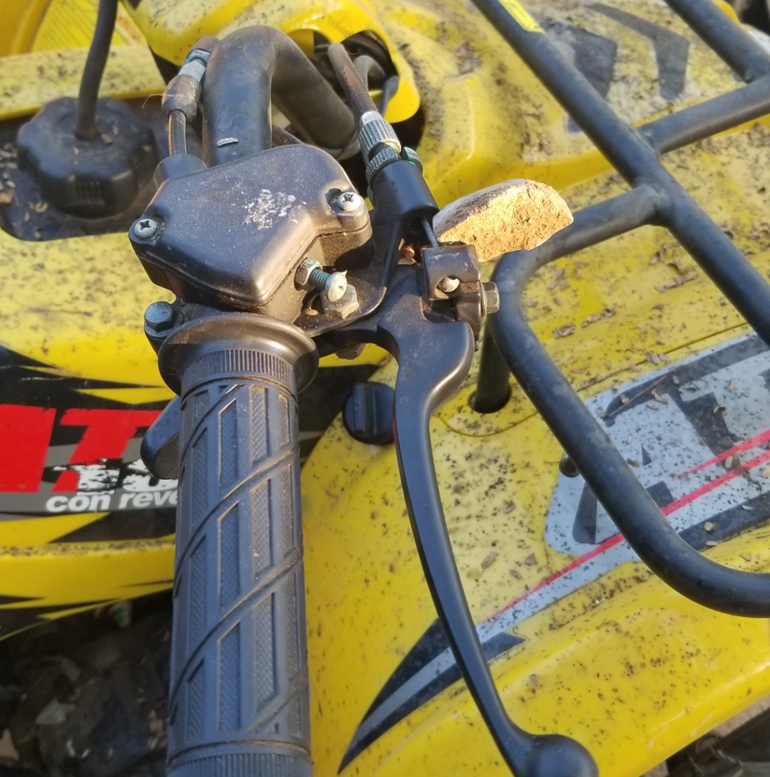 This ATV didn't have a parking brake. I "made" one with a rock I stuck