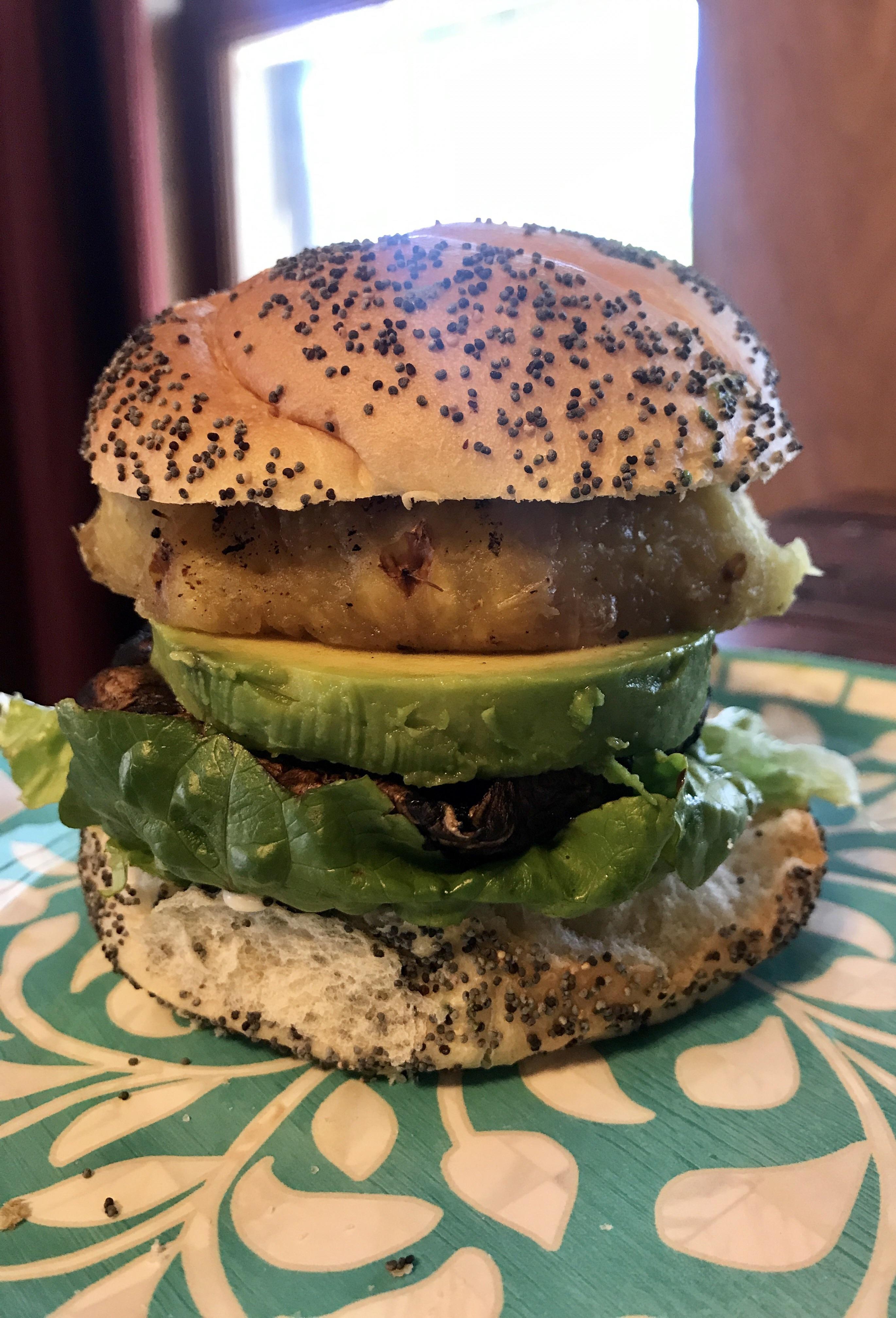 Grilled teriyaki marinated portobello mushroom burger with avocado