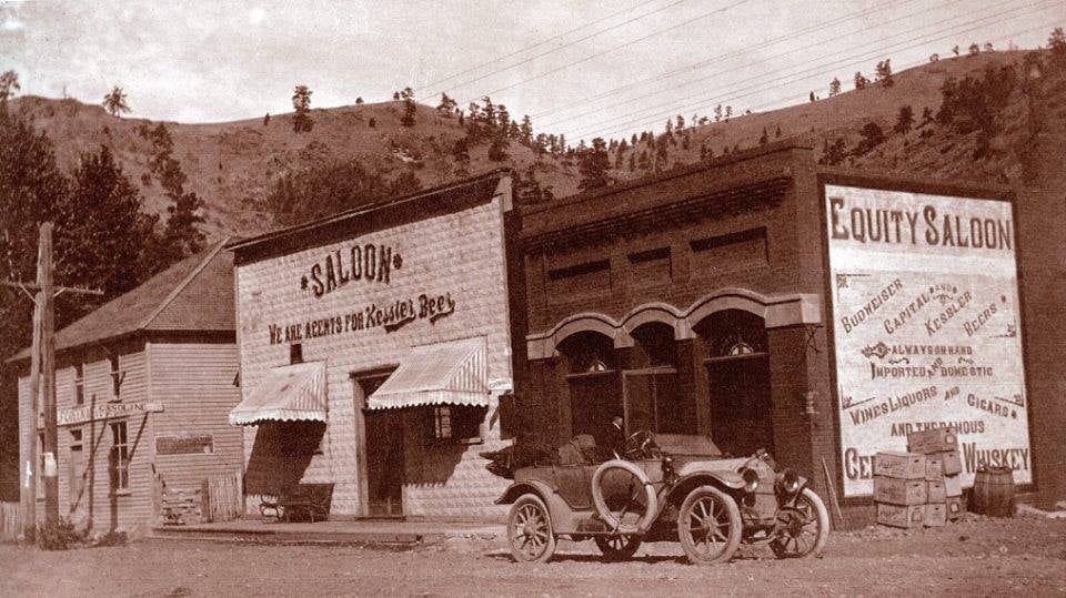 Outside the Equity Saloon in Wolf Creek, Montana in 1913 r/Montana