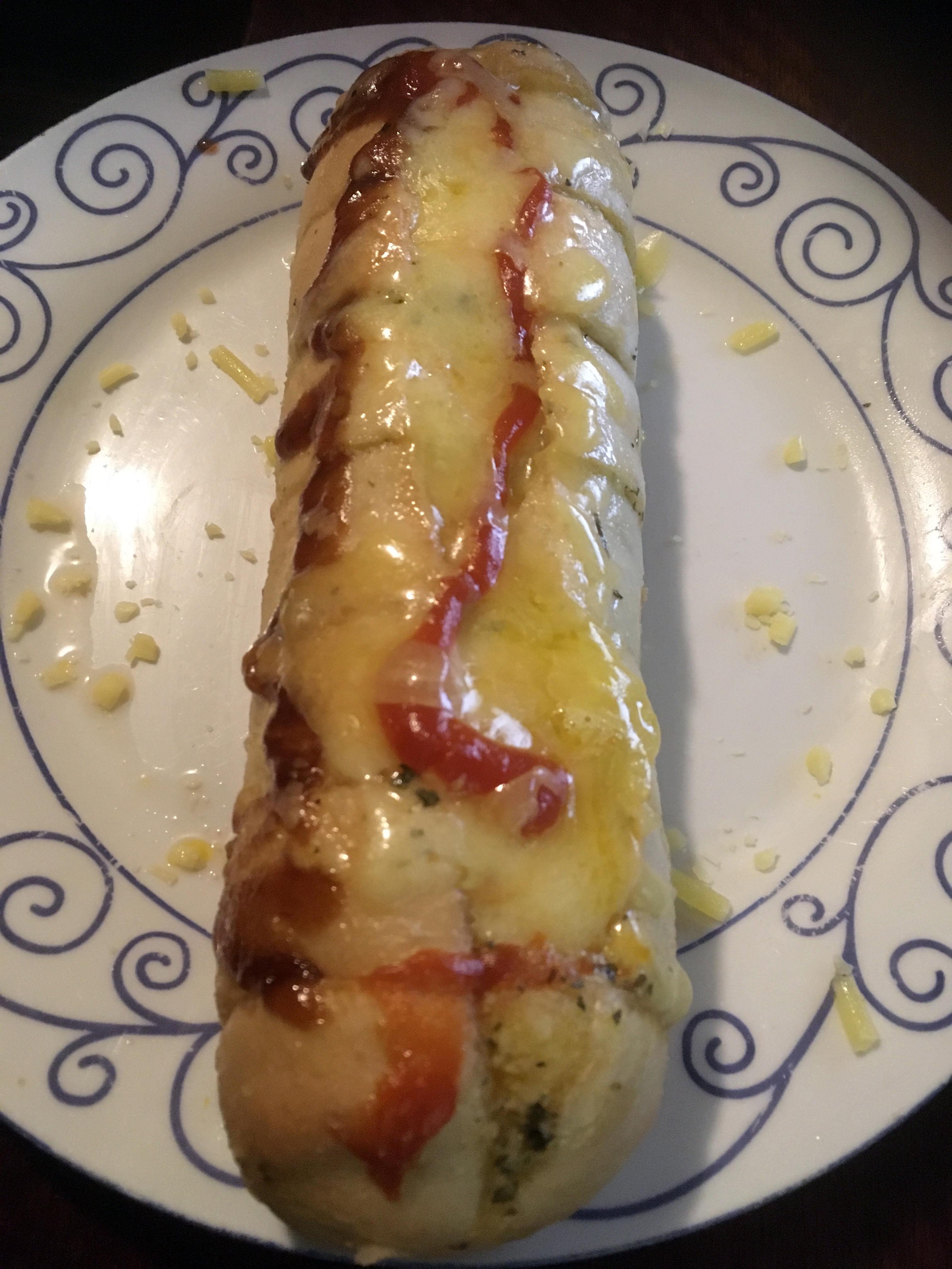 Microwaved frozen home brand garlic bread with cheese, tomato and bbq