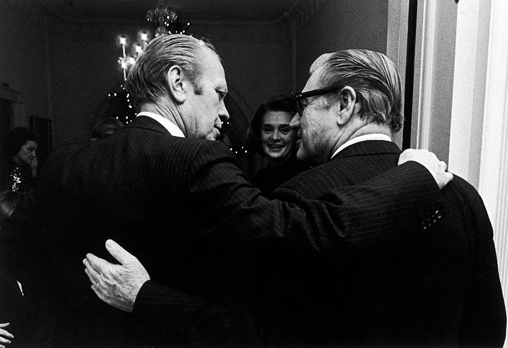 President Gerald Ford & Vice President Nelson Rockefeller stand arm in arm in the White House