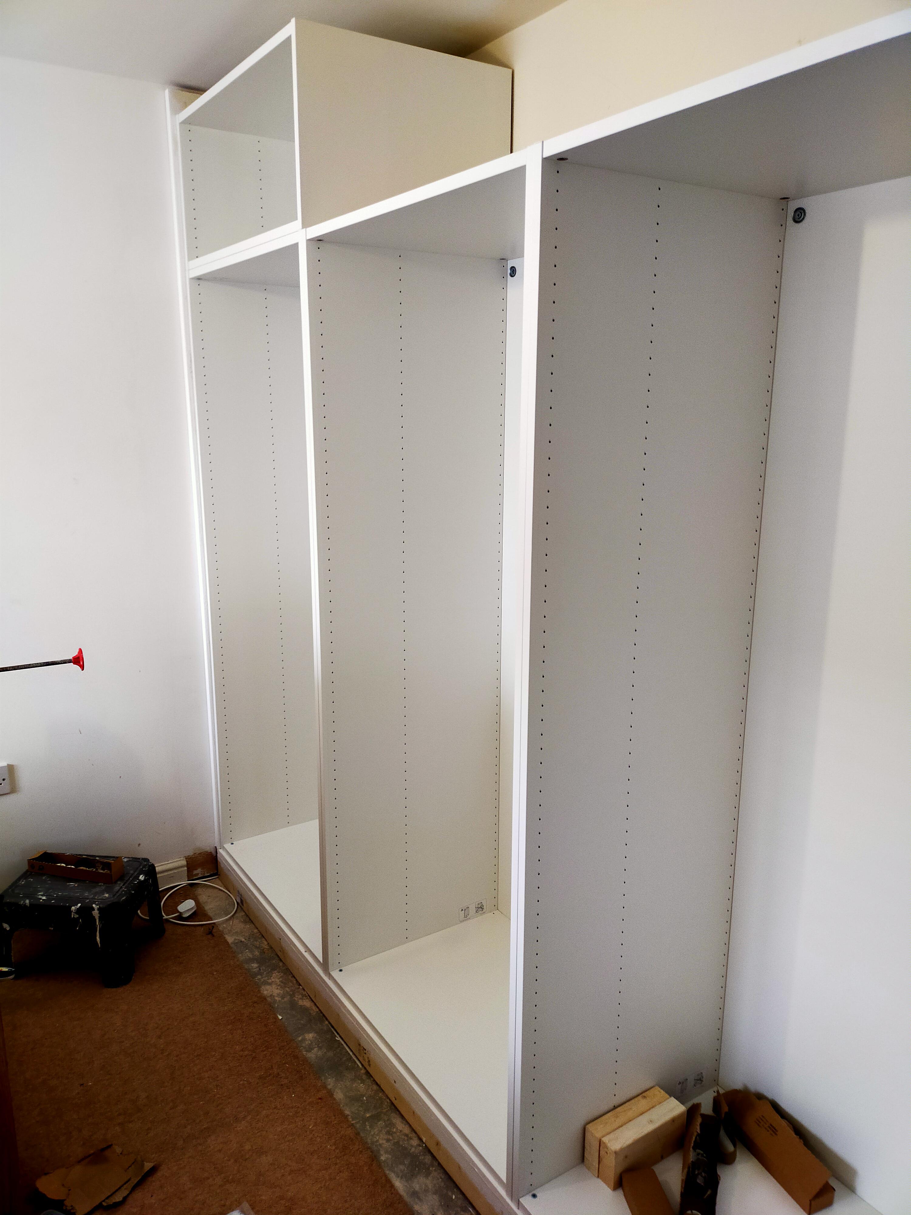 A wall of Platsa wardrobes going in. Built a custom plinth for them to