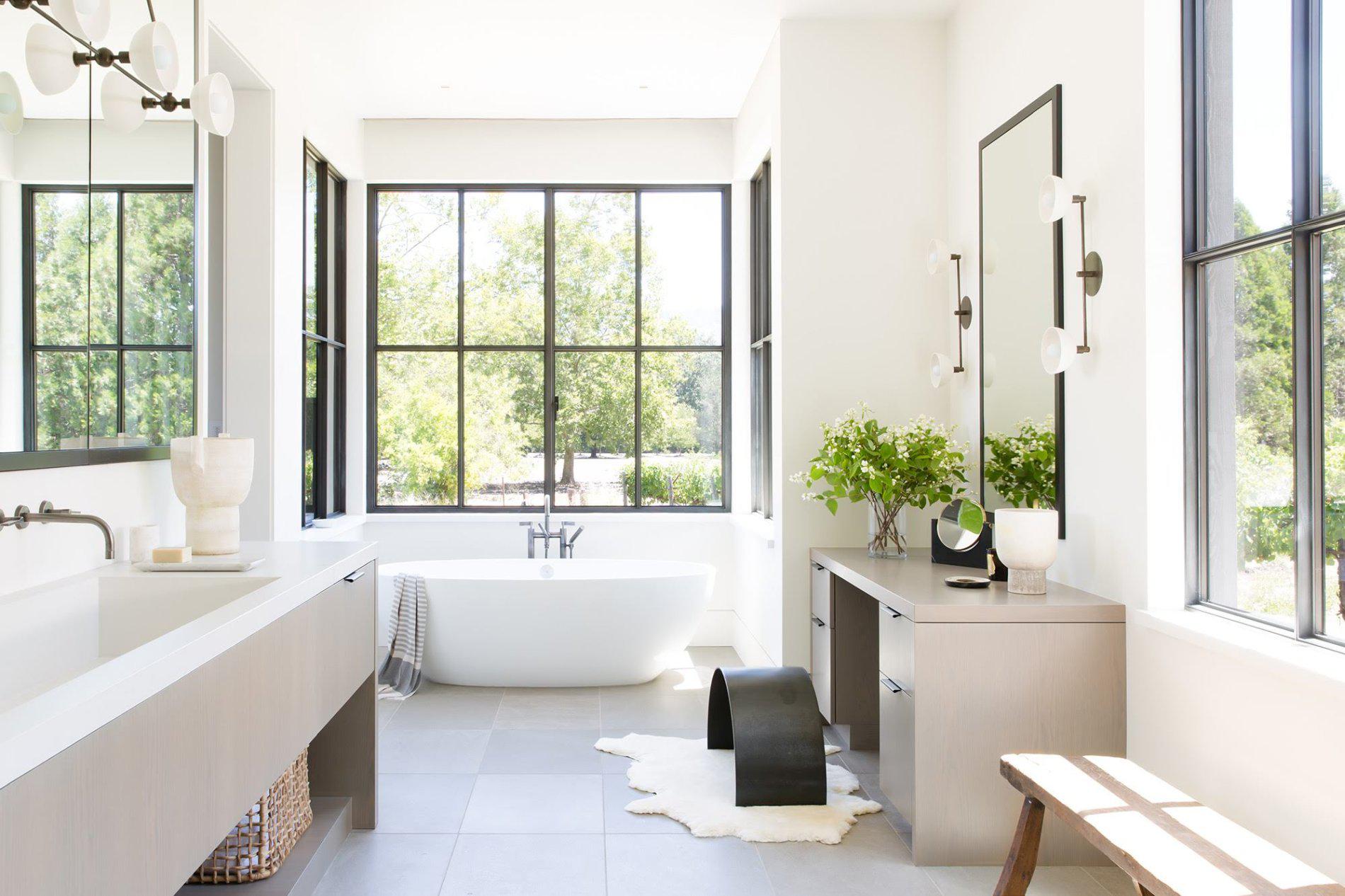 Lightfilled bathroom with large windows opening up to views of the
