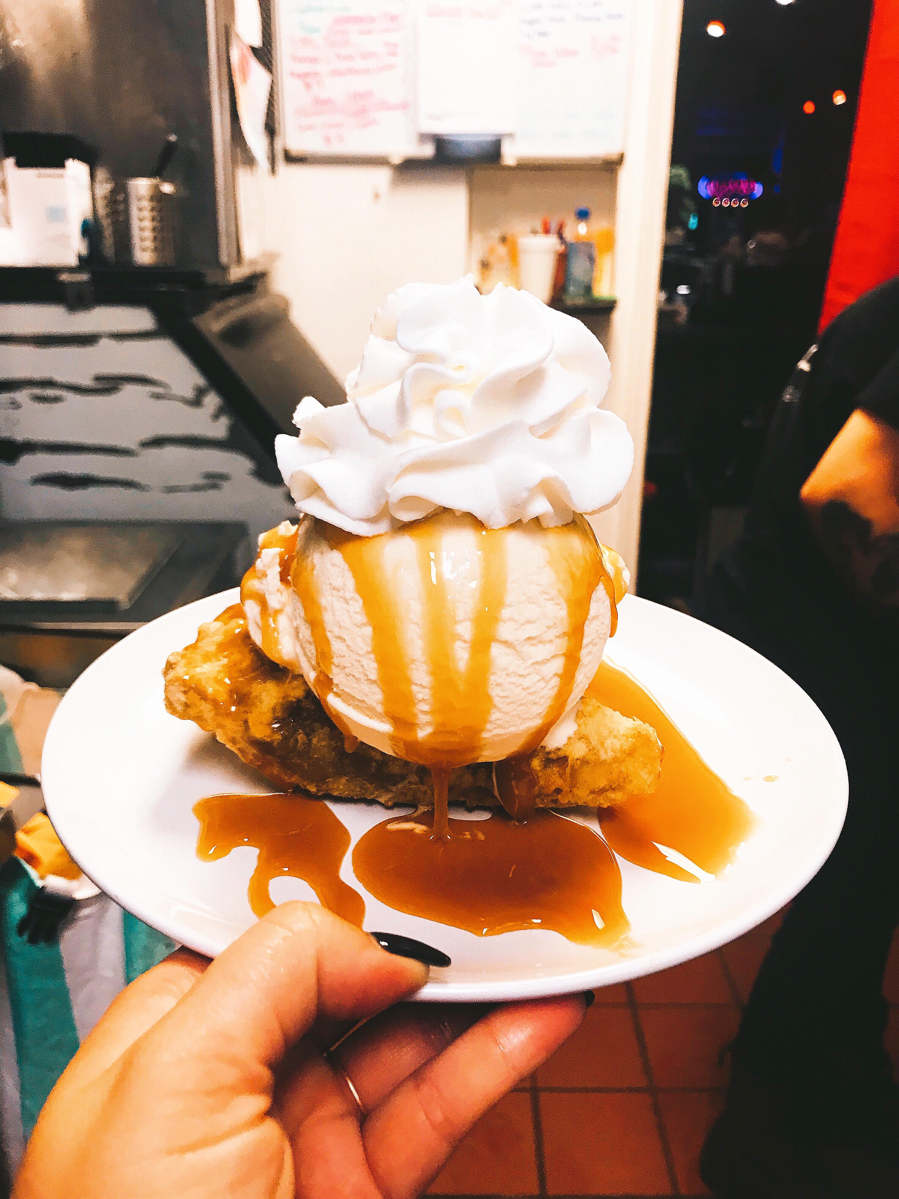 Deep fried apple pie with vanilla ice cream and a caramel drizzle r